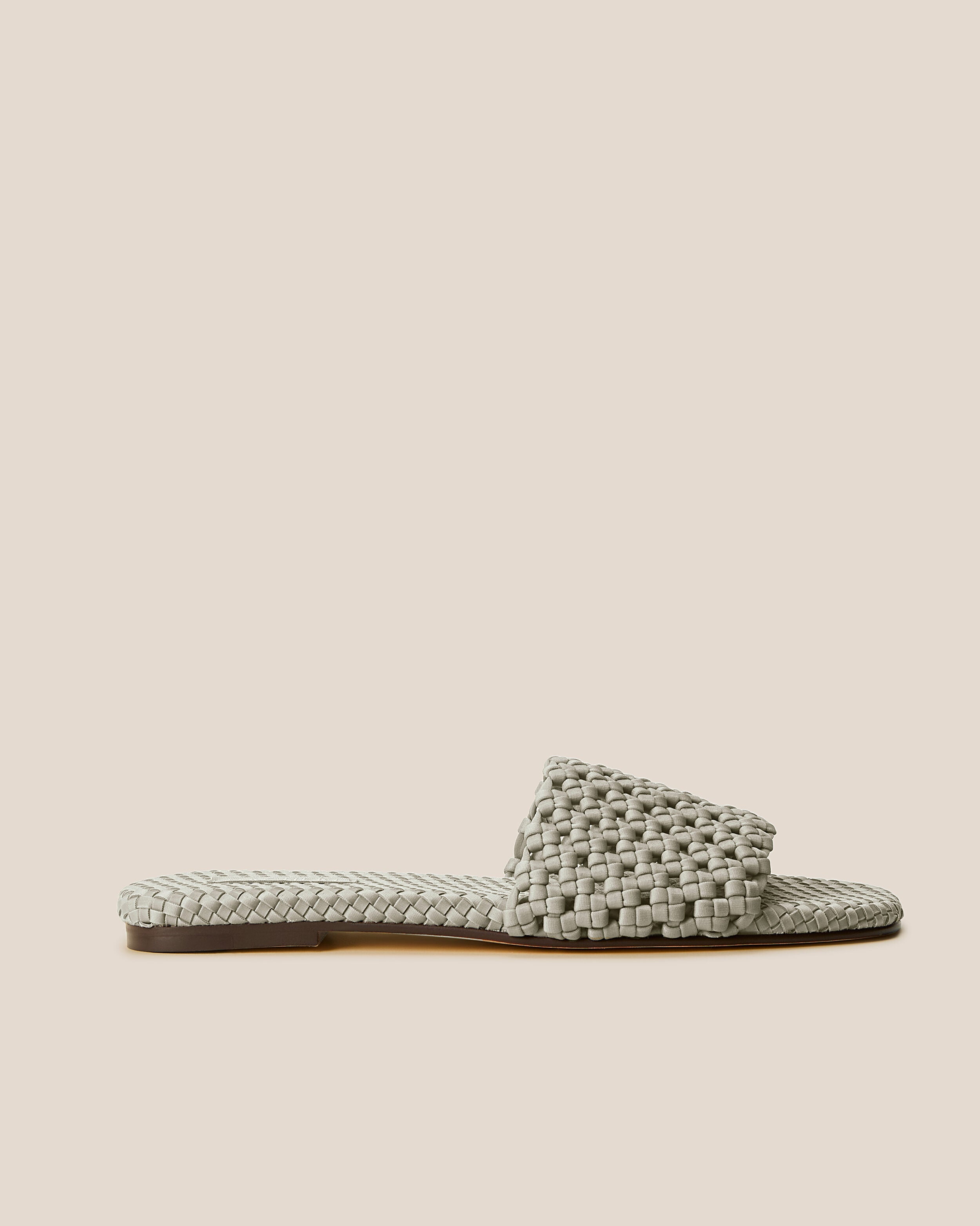 Side view of The Ojai Slide in Celadon, a light jade green tone, featuring an open toe and round silhouette.