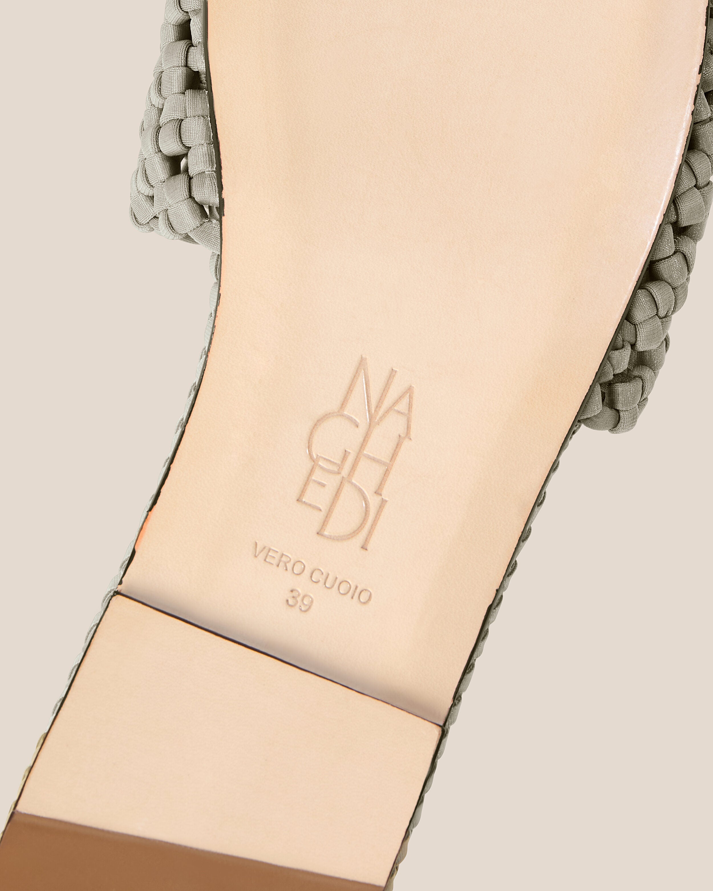 Shoe sole showing natural buffed leather sole, stamped NAGHEDI logo and size detail for The Ojai Slide in Celadon.
