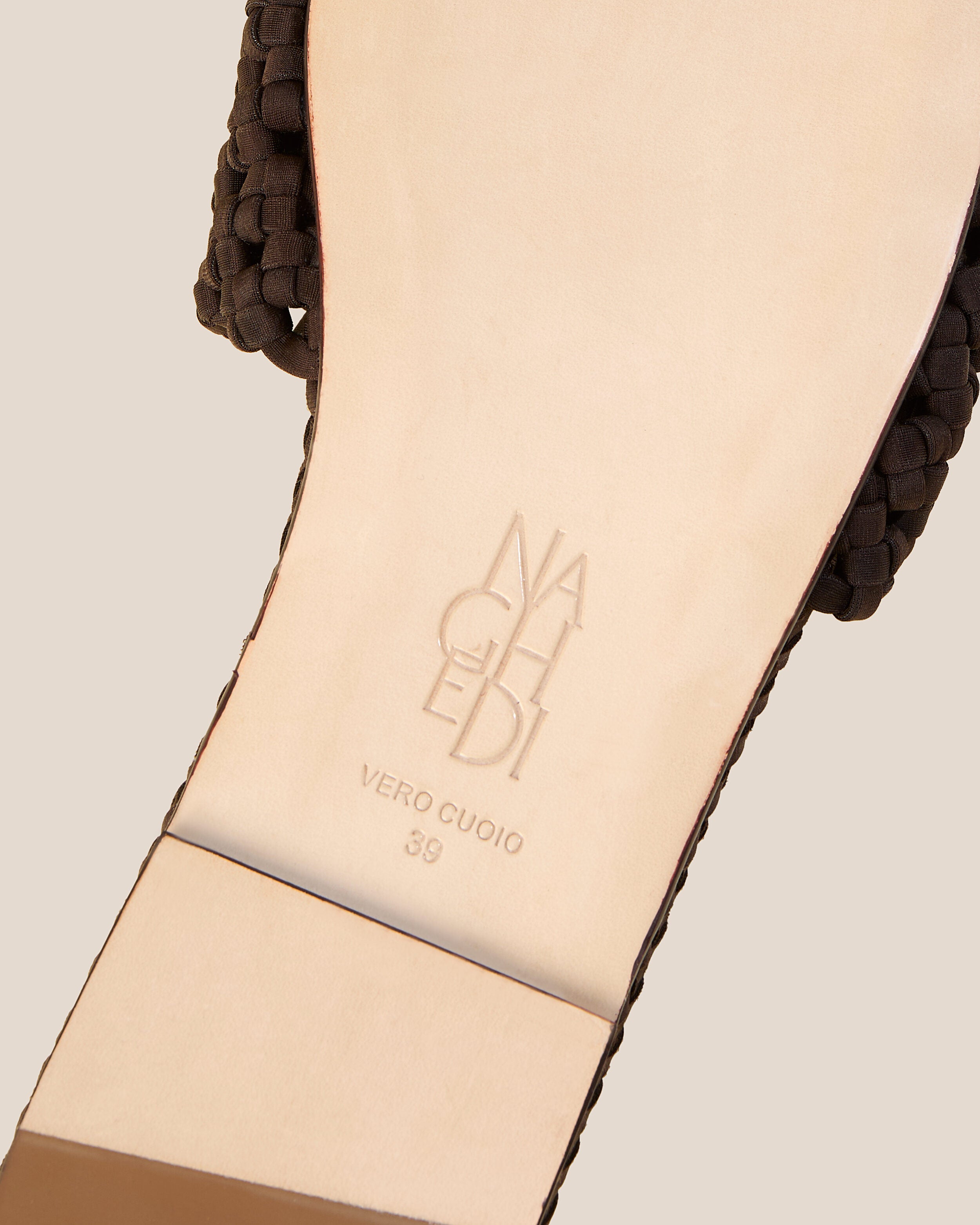 Shoe sole showing natural buffed leather sole, stamped NAGHEDI logo and size detail for The Ojai Slide in Chocolate.
