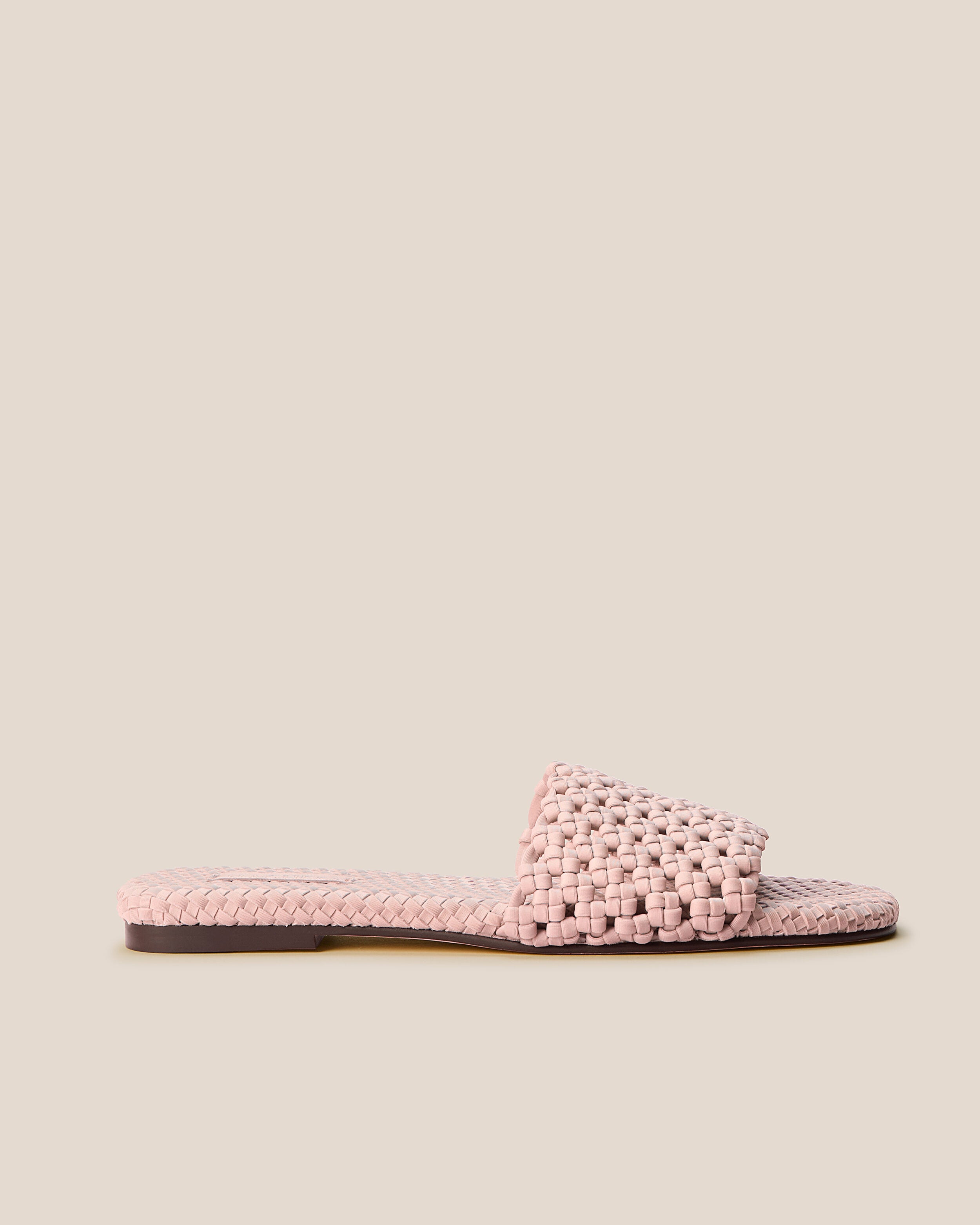 Side view of The Ojai Slide in Petal, a petal pink tone, featuring an open toe and round silhouette.