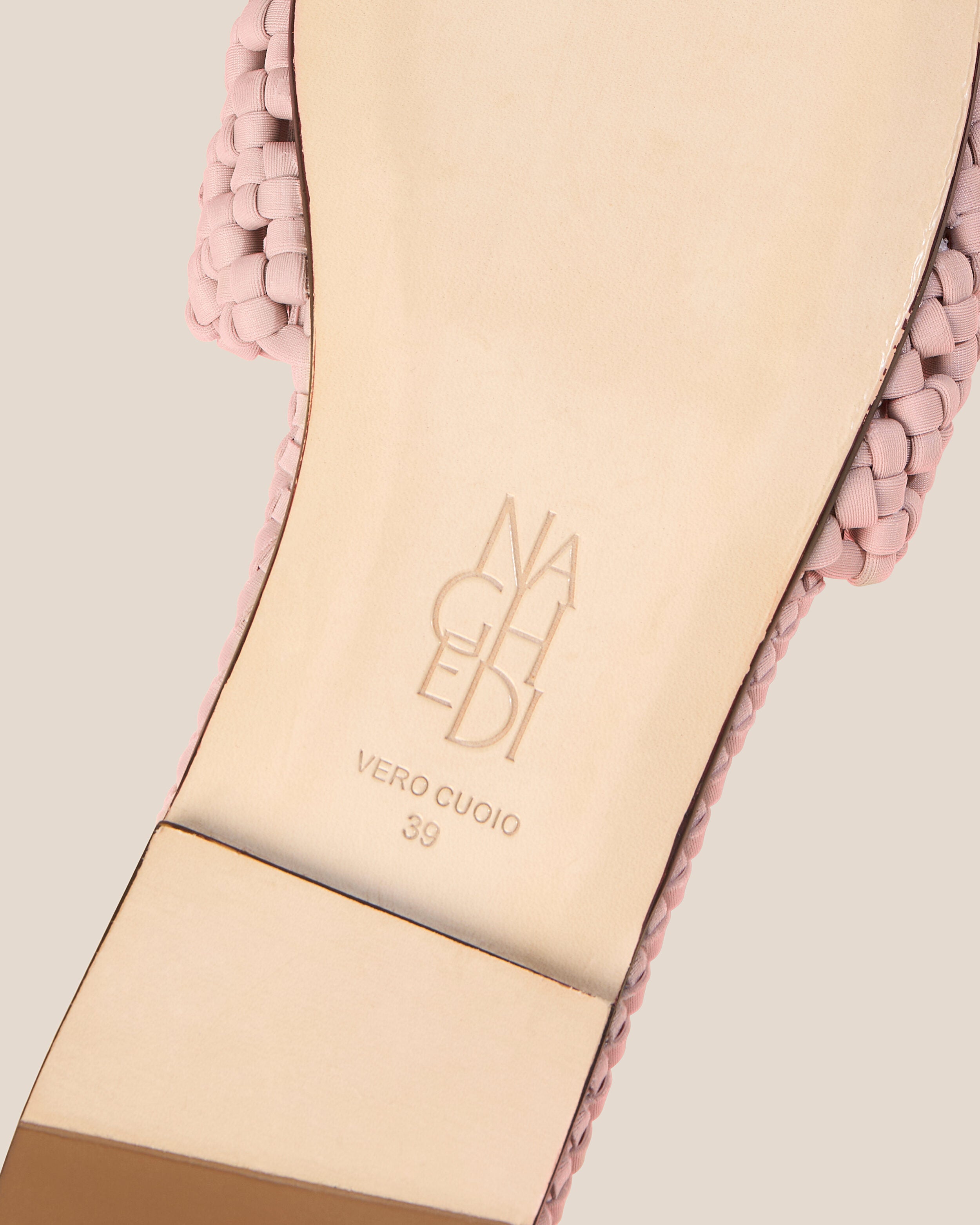 Shoe sole showing natural buffed leather sole, stamped NAGHEDI logo and size detail for The Ojai Slide in Petal.