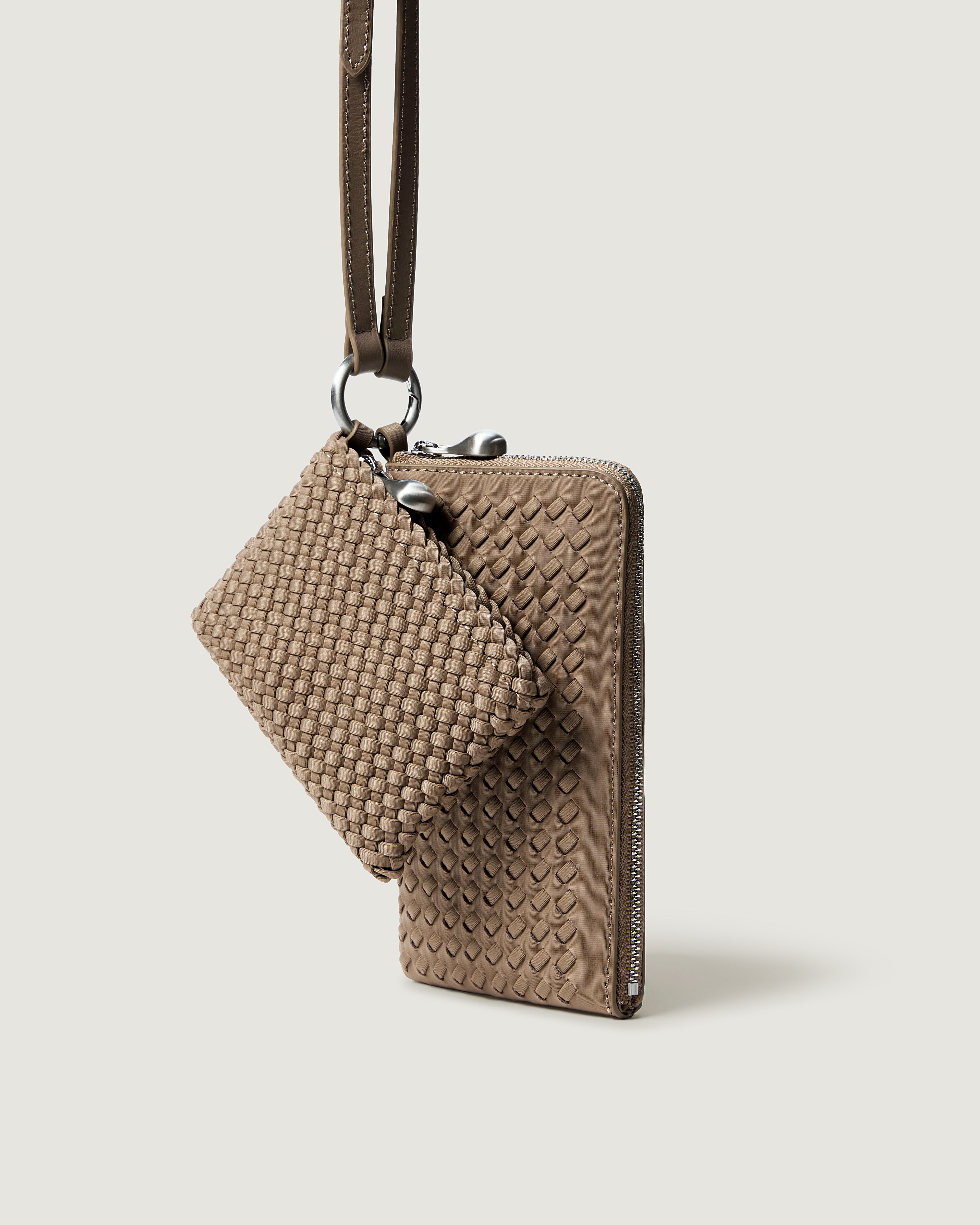 A handwoven neoprene crossbody zippered phone case in a taupe-brown color, featuring a matching zippered card holder pouch and a thin adjustable shoulder strap.