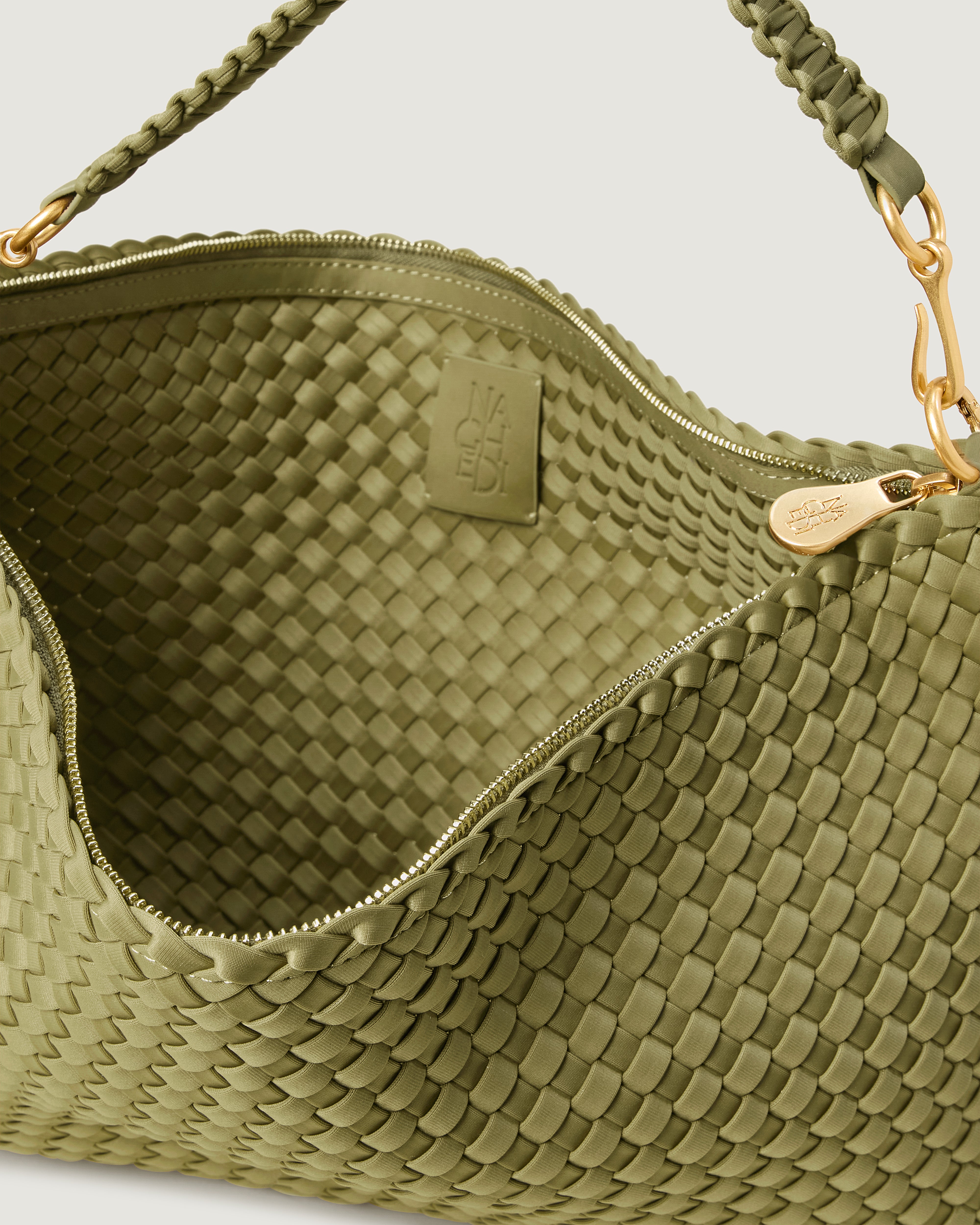 Interior close-up of Porto Half-Moon in Bottle Green showing its zip closure, and unlined interior.