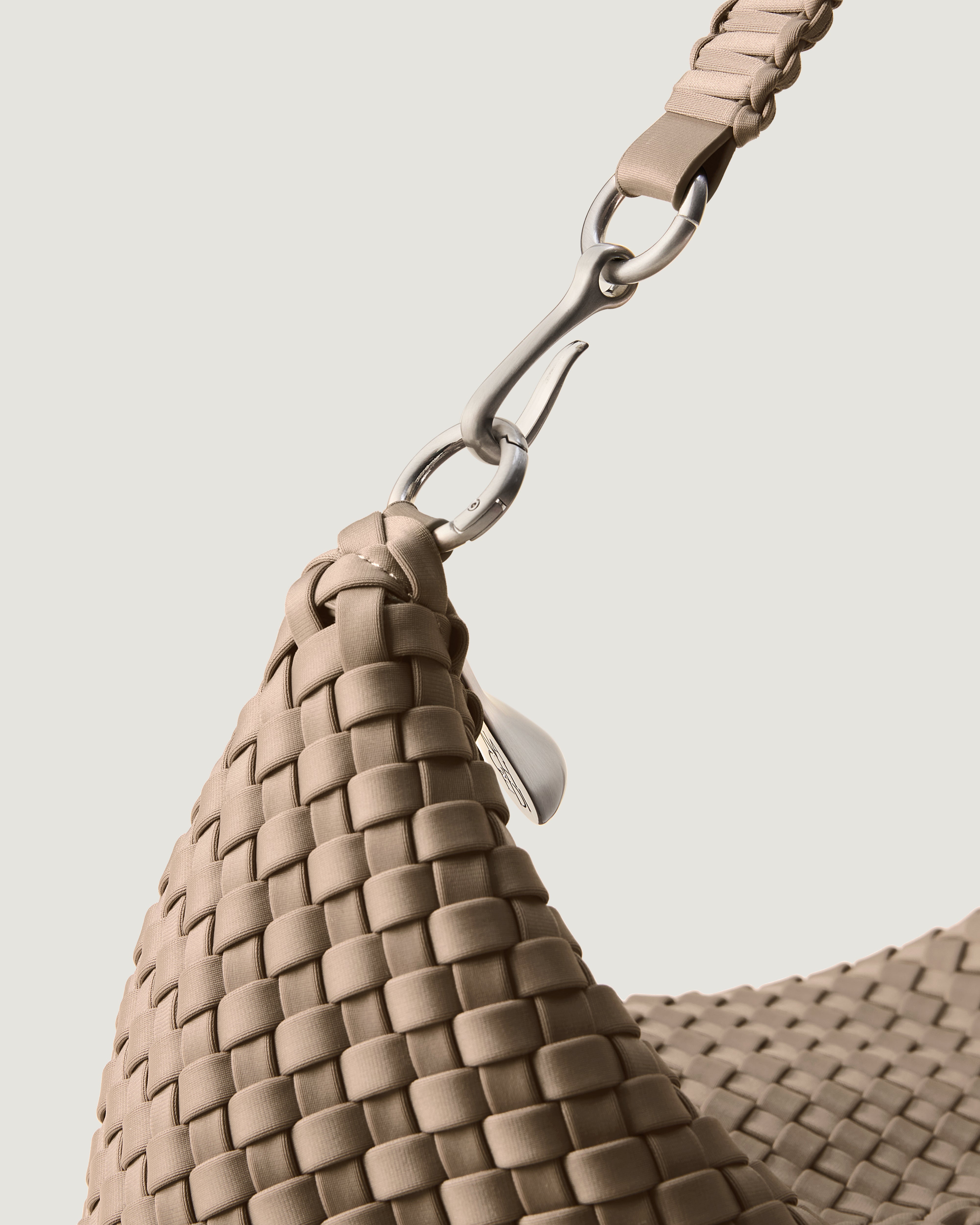 Close-up of zip closure and custom strap hardware.