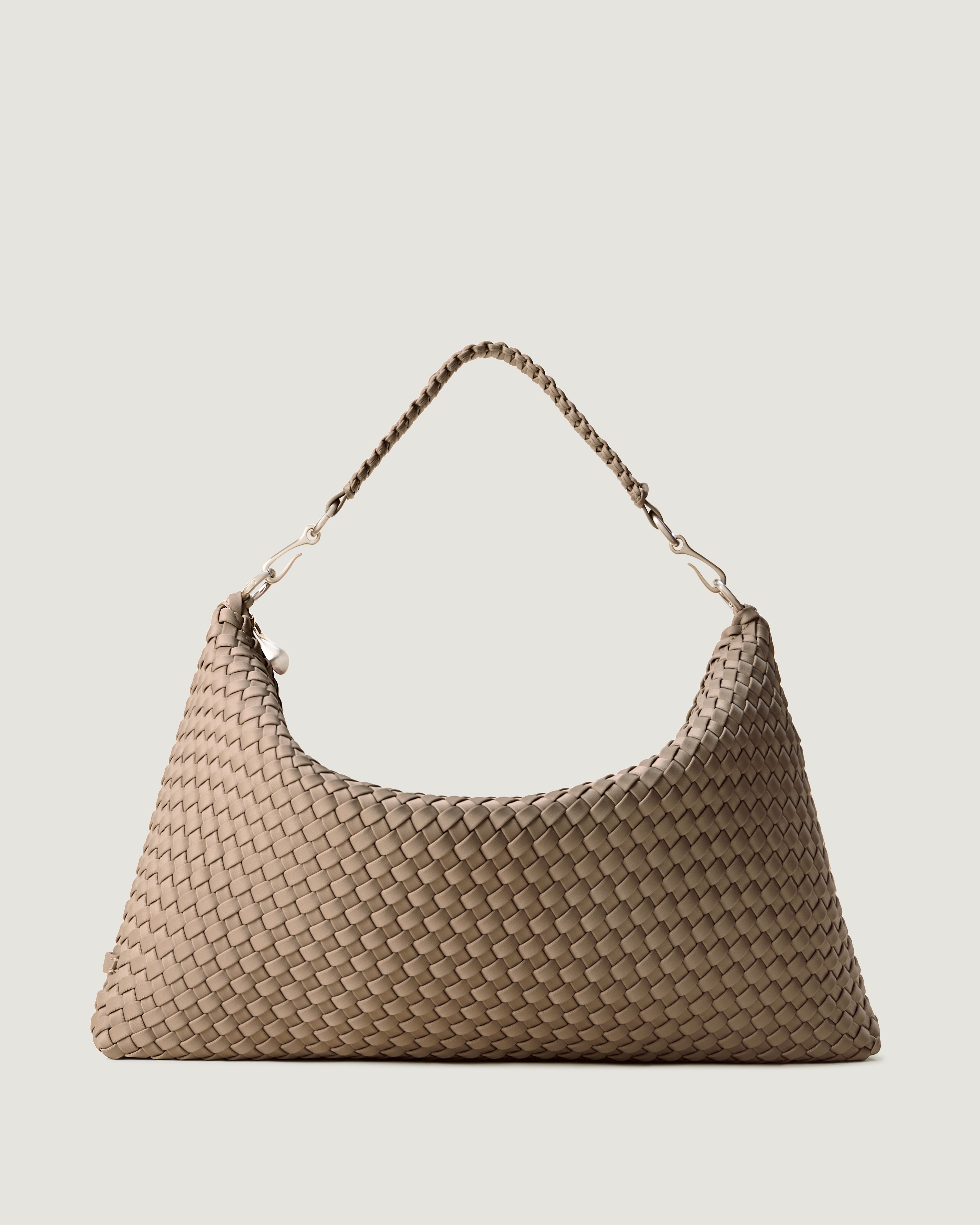 Porto Half-Moon in Cashmere, a taupe tone, in handwoven neoprene, featuring a zip closure, and strap with hand-stitched detailing.