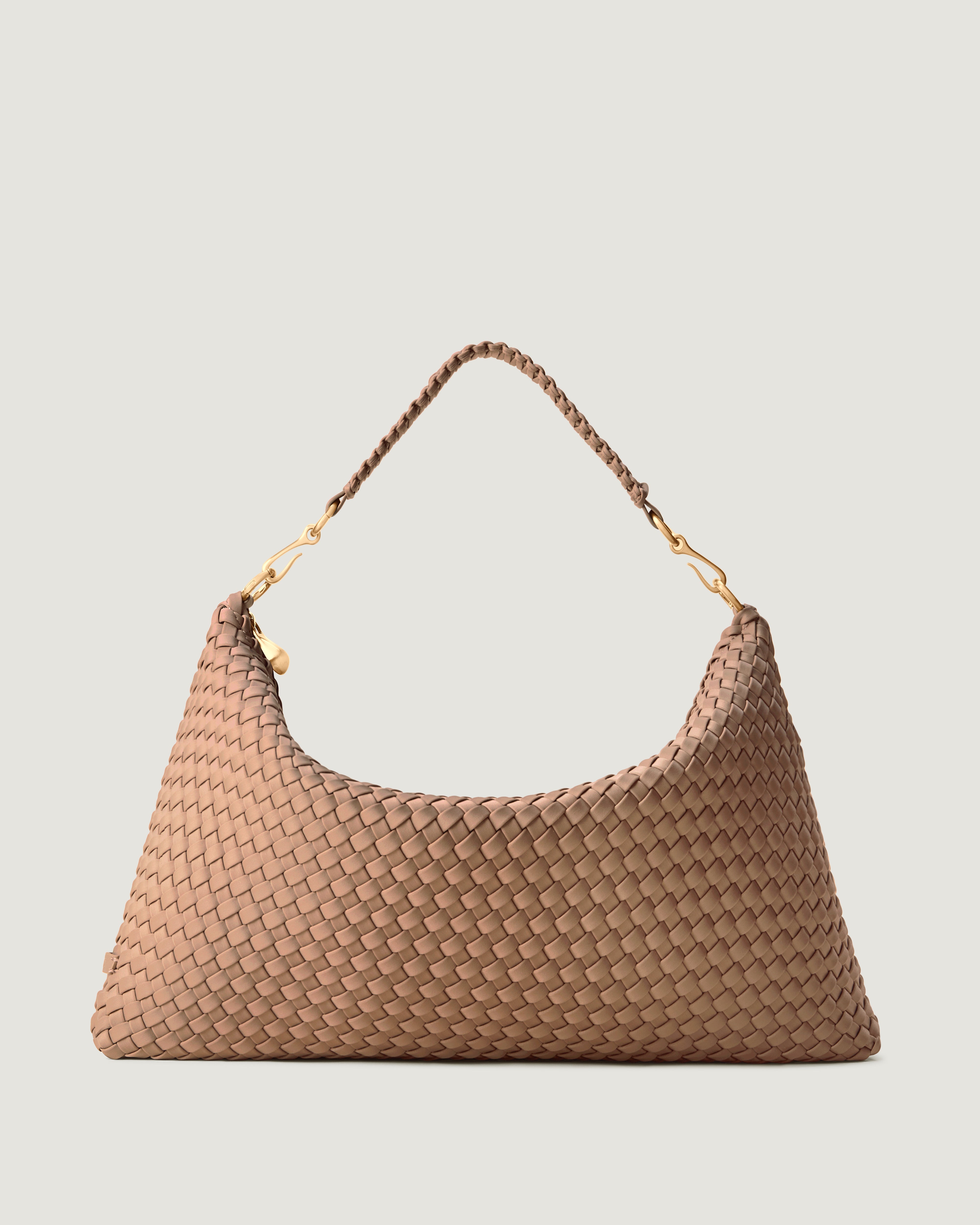 Porto Half-Moon in Seychelles, a light beige tone, in handwoven neoprene, featuring a zip closure, and strap with hand-stitched detailing.