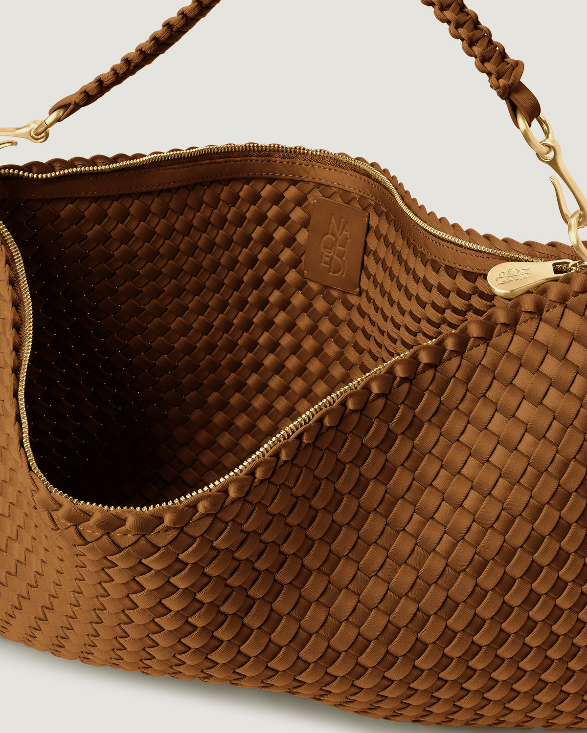 Interior close-up of Porto Medium Half-Moon in Teak showing its zip closure, and unlined interior.
