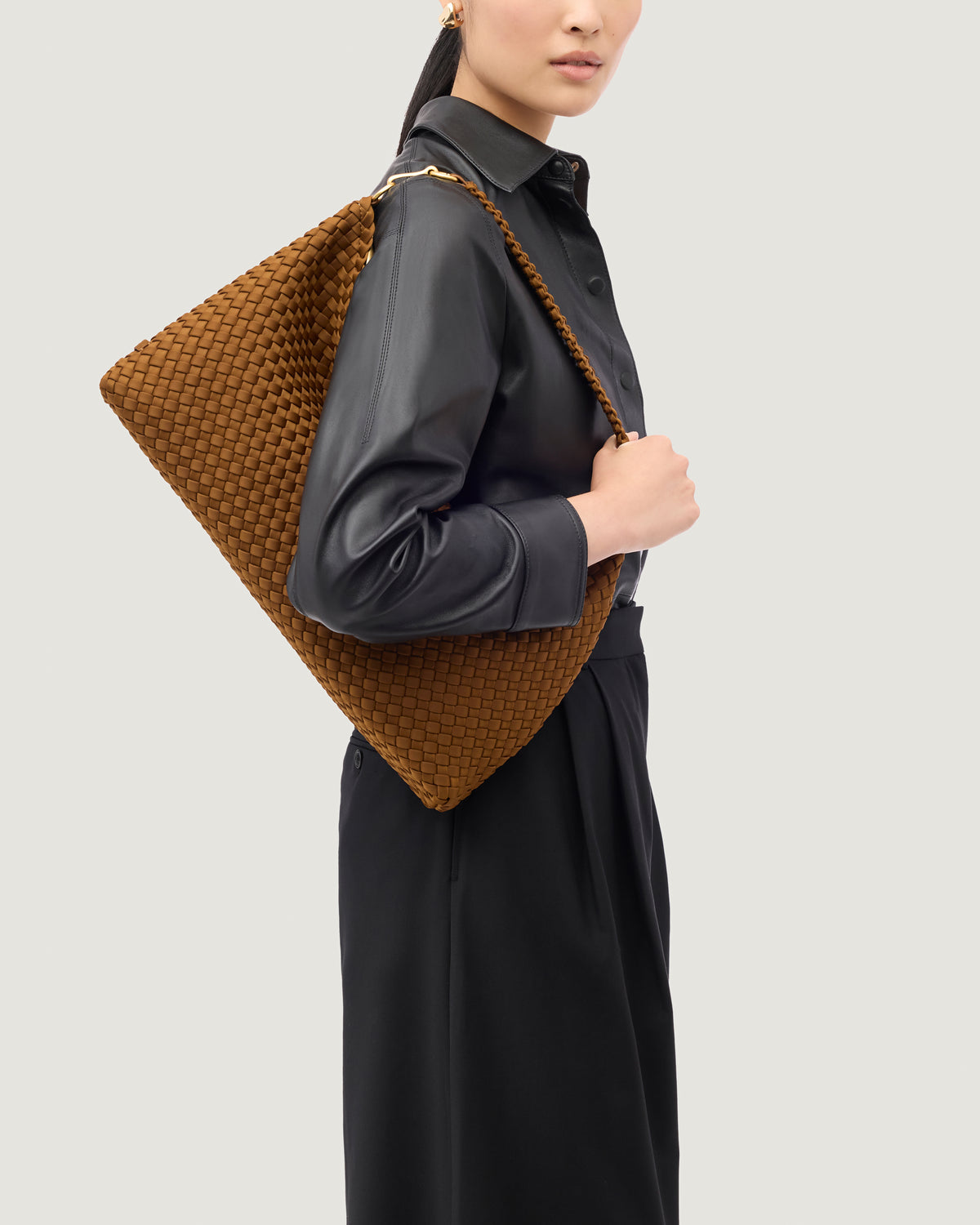 Porto Half-Moon in Teak shown on model to illustrate scale and soft silhouette.