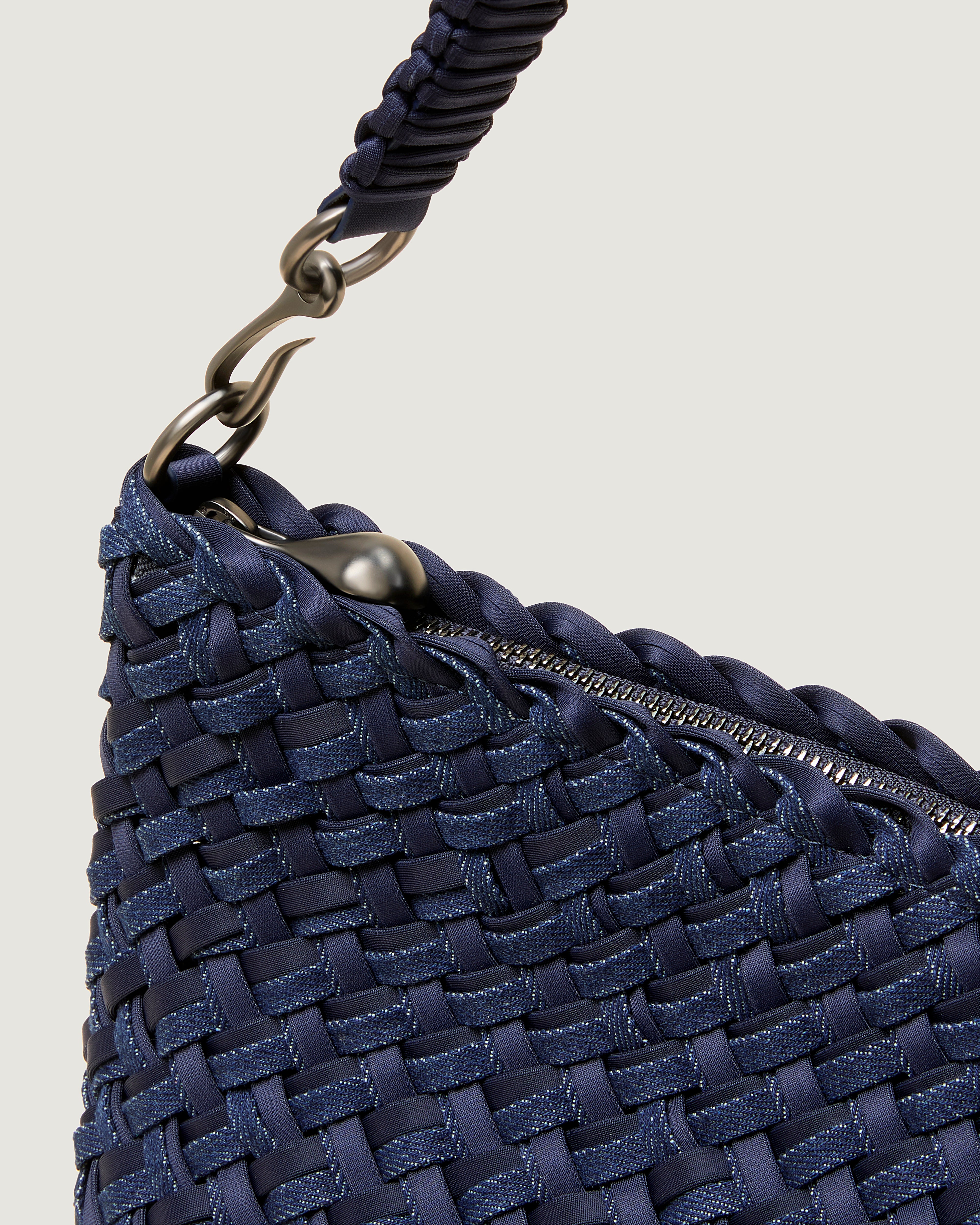 Close-up of zip closure and custom strap hardware.