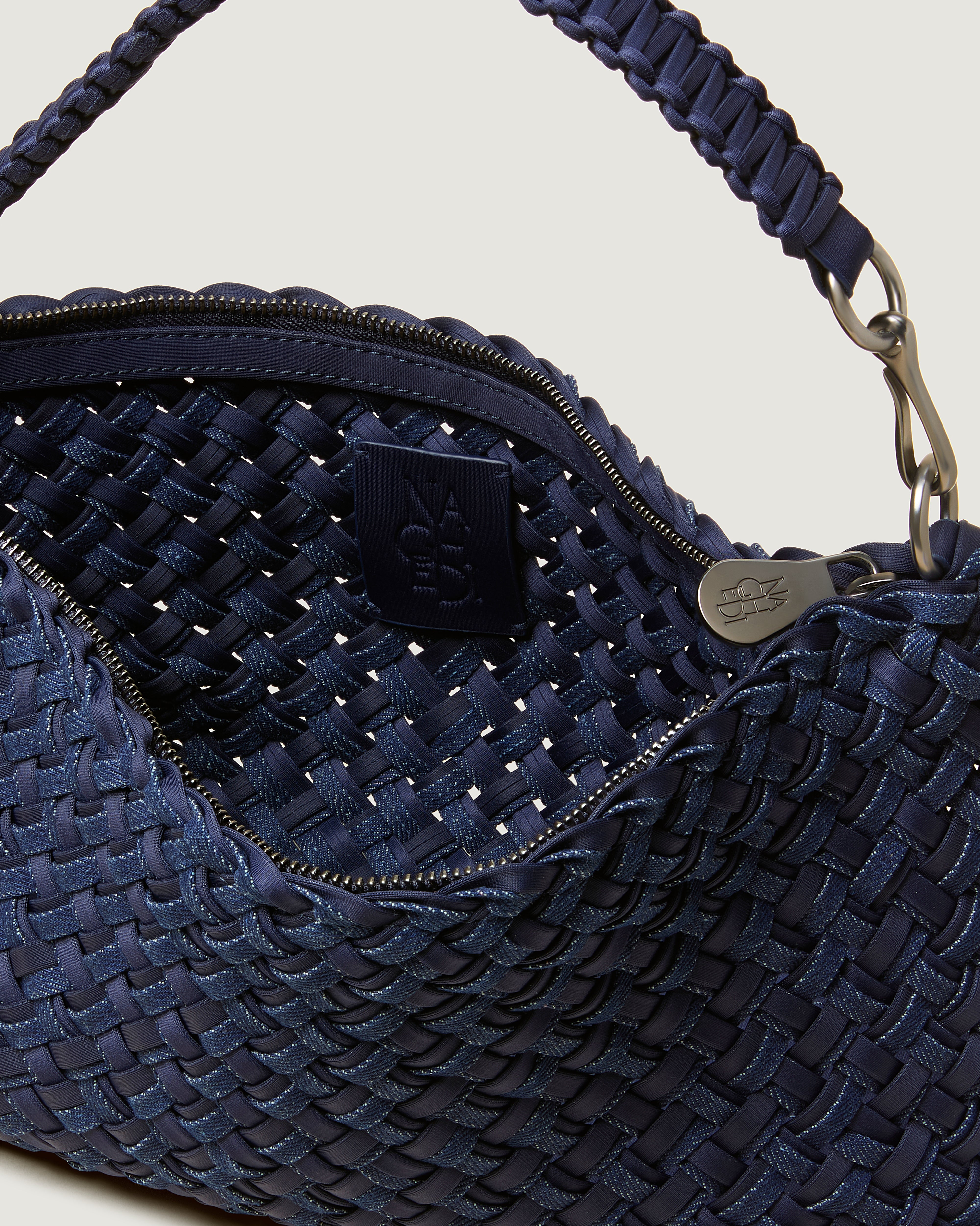 Interior close-up of Porto Half-Moon in Indigo showing its zip closure, and unlined interior.