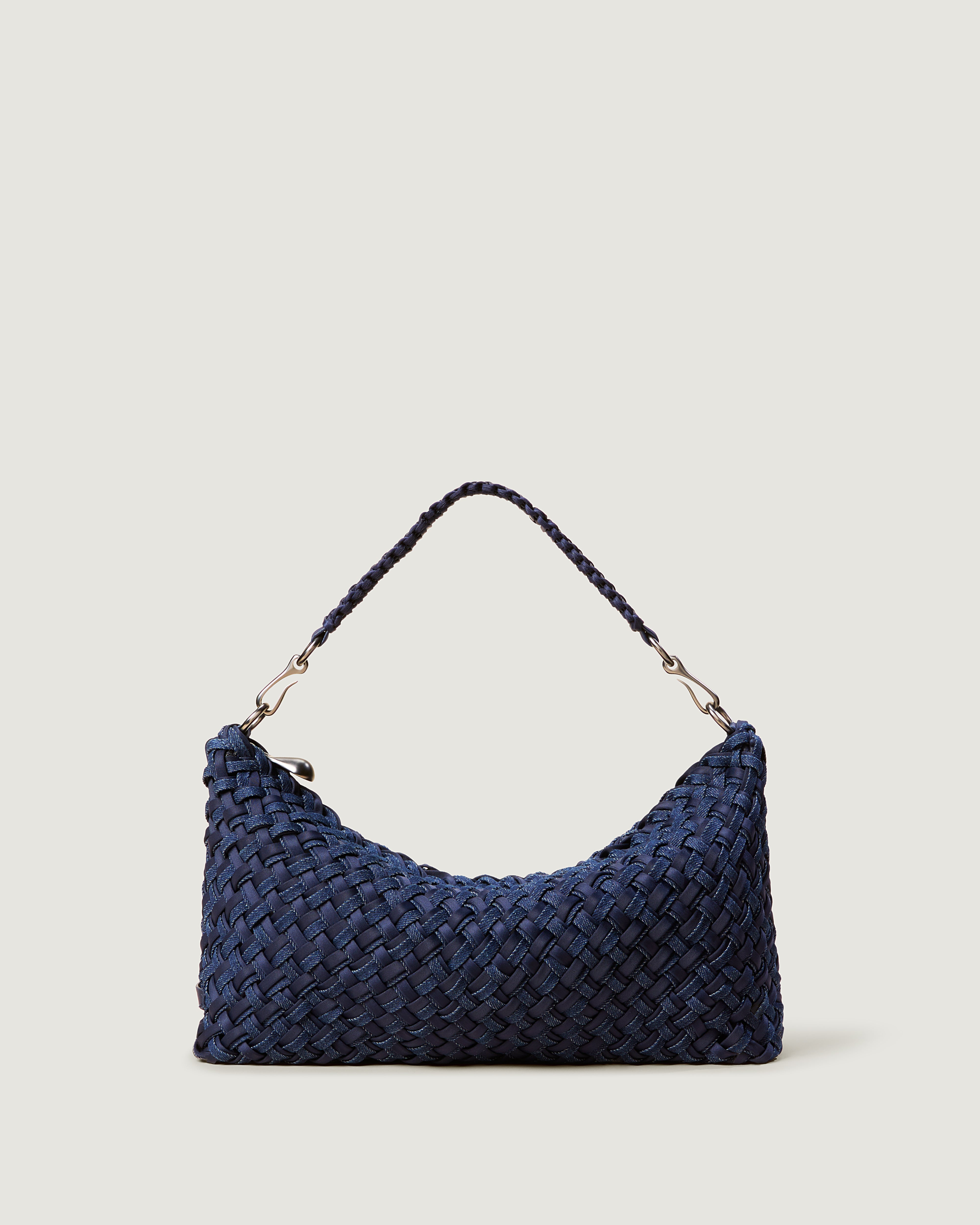 Porto Half-Moon in Indigo with doubled strands of navy blue neoprene with indigo denim. Featuring a zip closure, and strap with hand-stitched detailing.