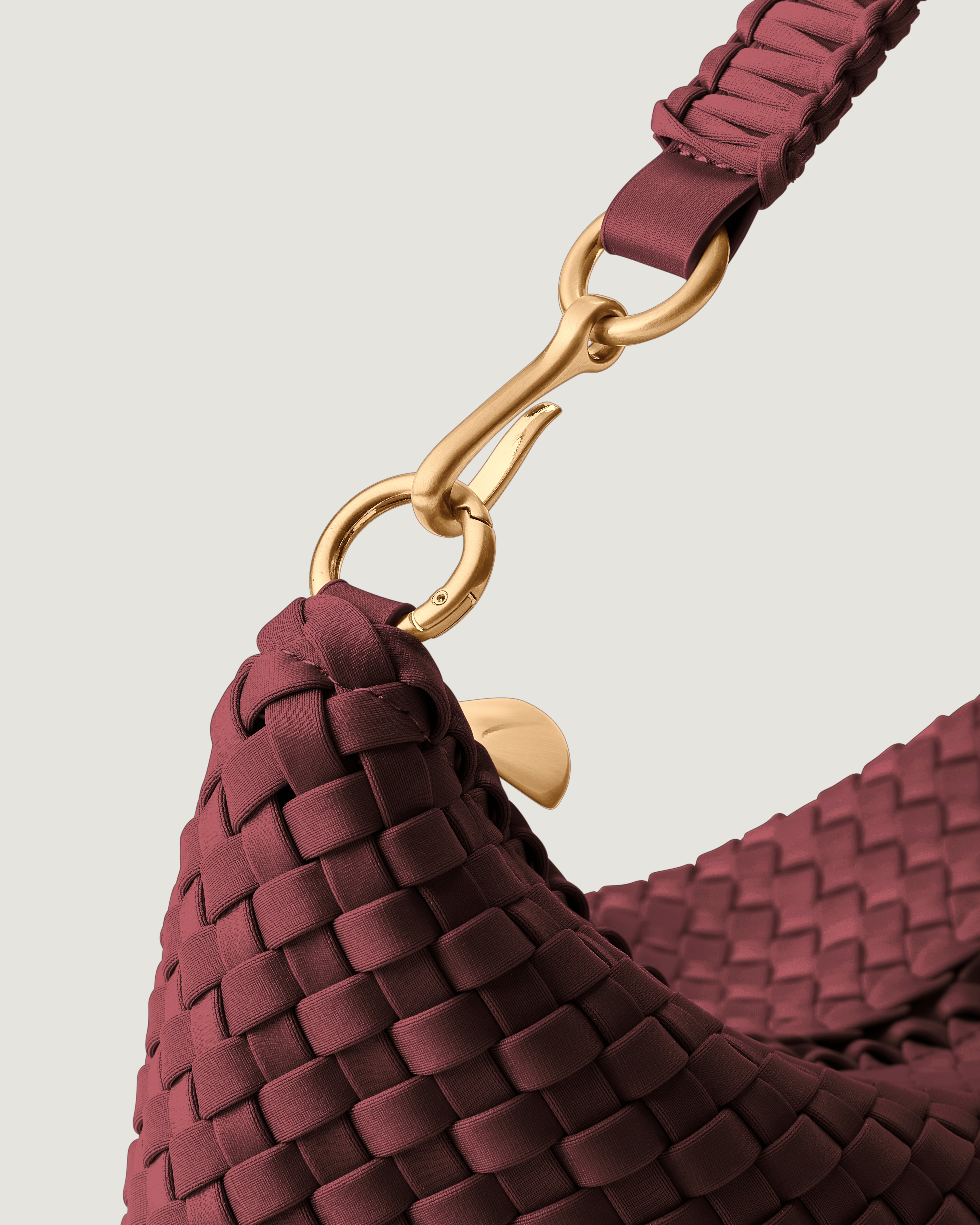 Close-up of zip closure and custom brushed gold strap hardware.