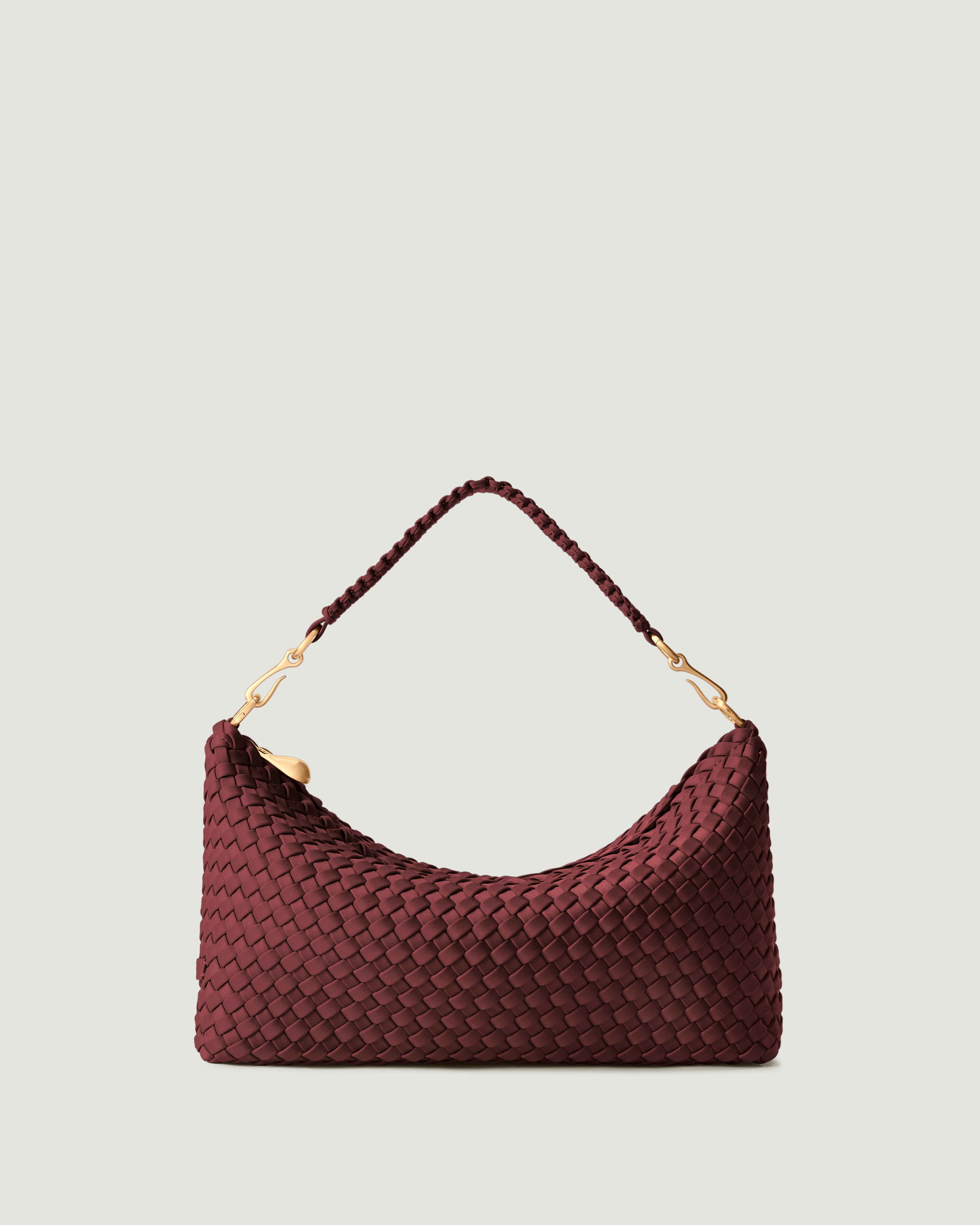 Porto Half-Moon in Bordeaux, a burgundy tone, in handwoven neoprene, featuring a zip closure, and strap with hand-stitched detailing.