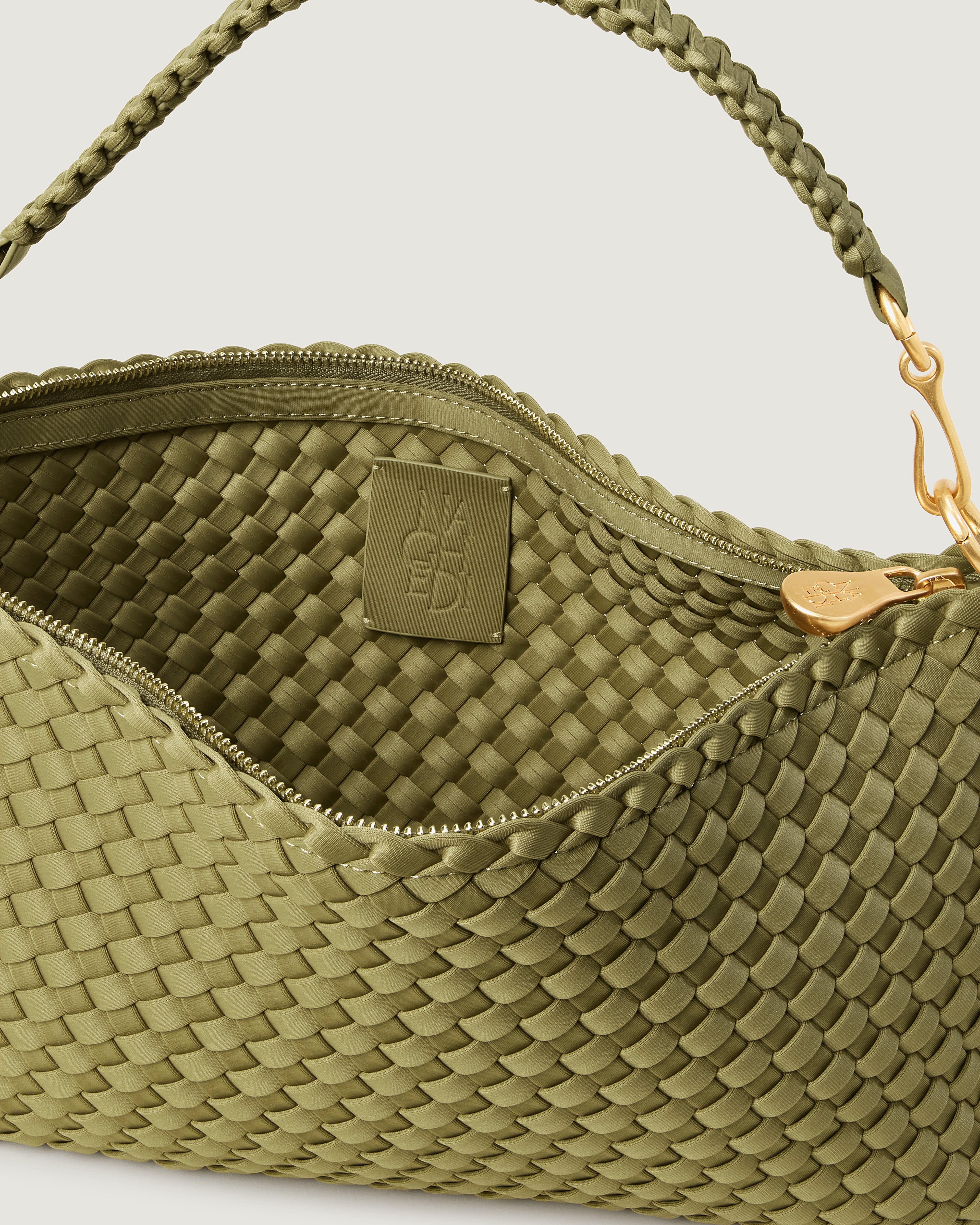 Interior close-up of Porto Half-Moon in Bottle Green showing its zip closure, and unlined interior.