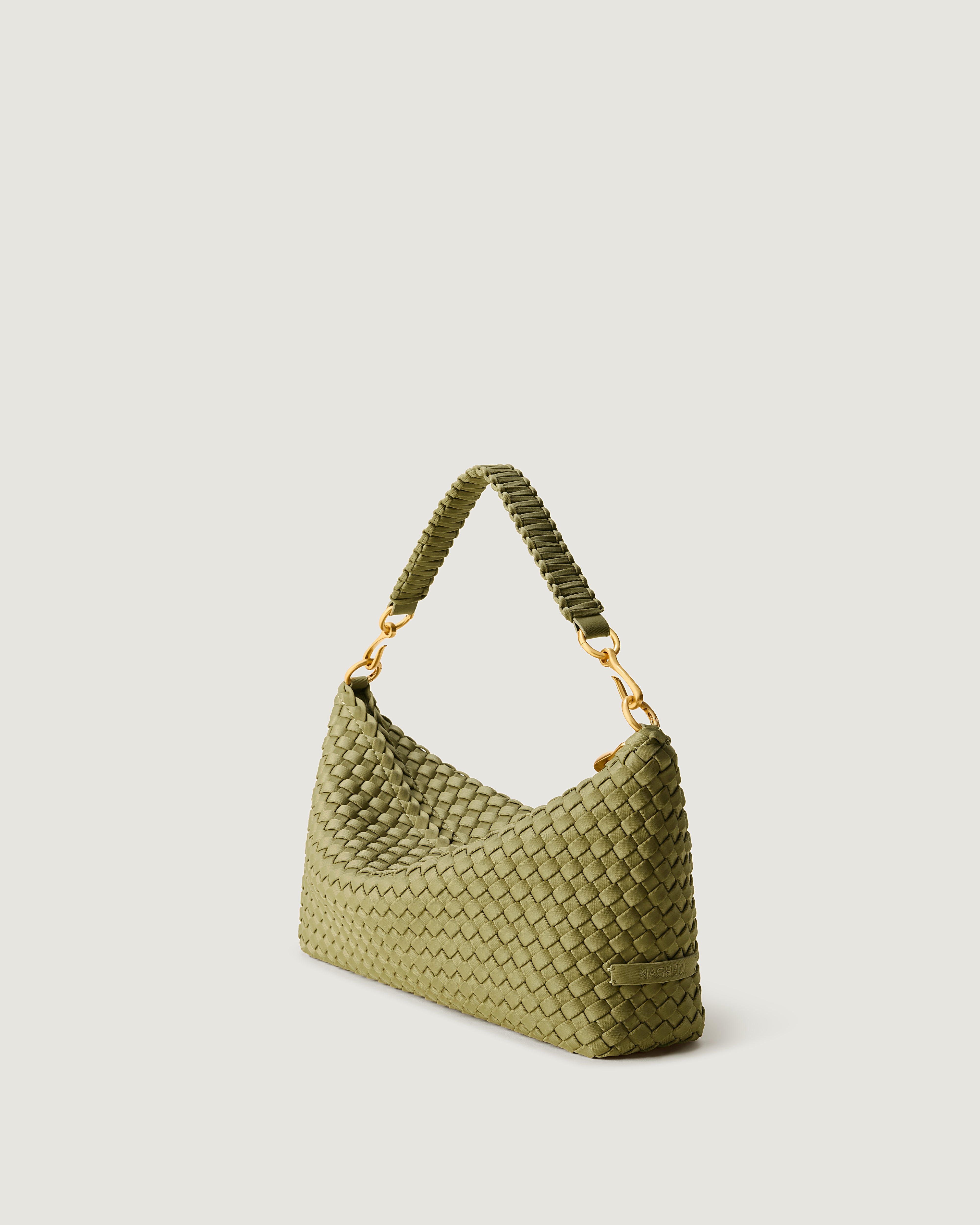 Porto Half-Moon in Bottle Green shown from a side angle, highlighting its handwoven neoprene construction and zip closure.