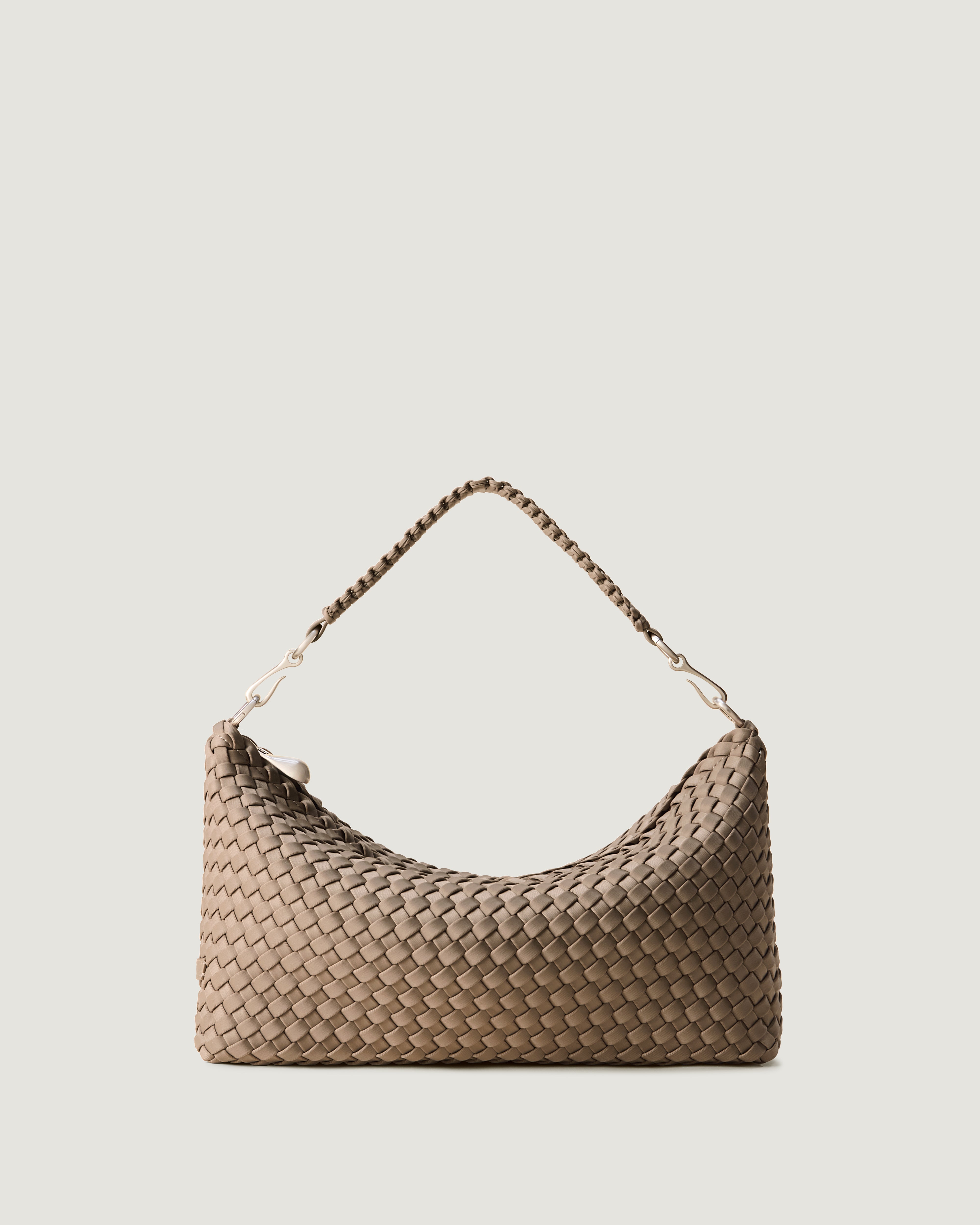 Porto Half-Moon in Cashmere, a taupe tone, in handwoven neoprene, featuring a zip closure, and strap with hand-stitched detailing.