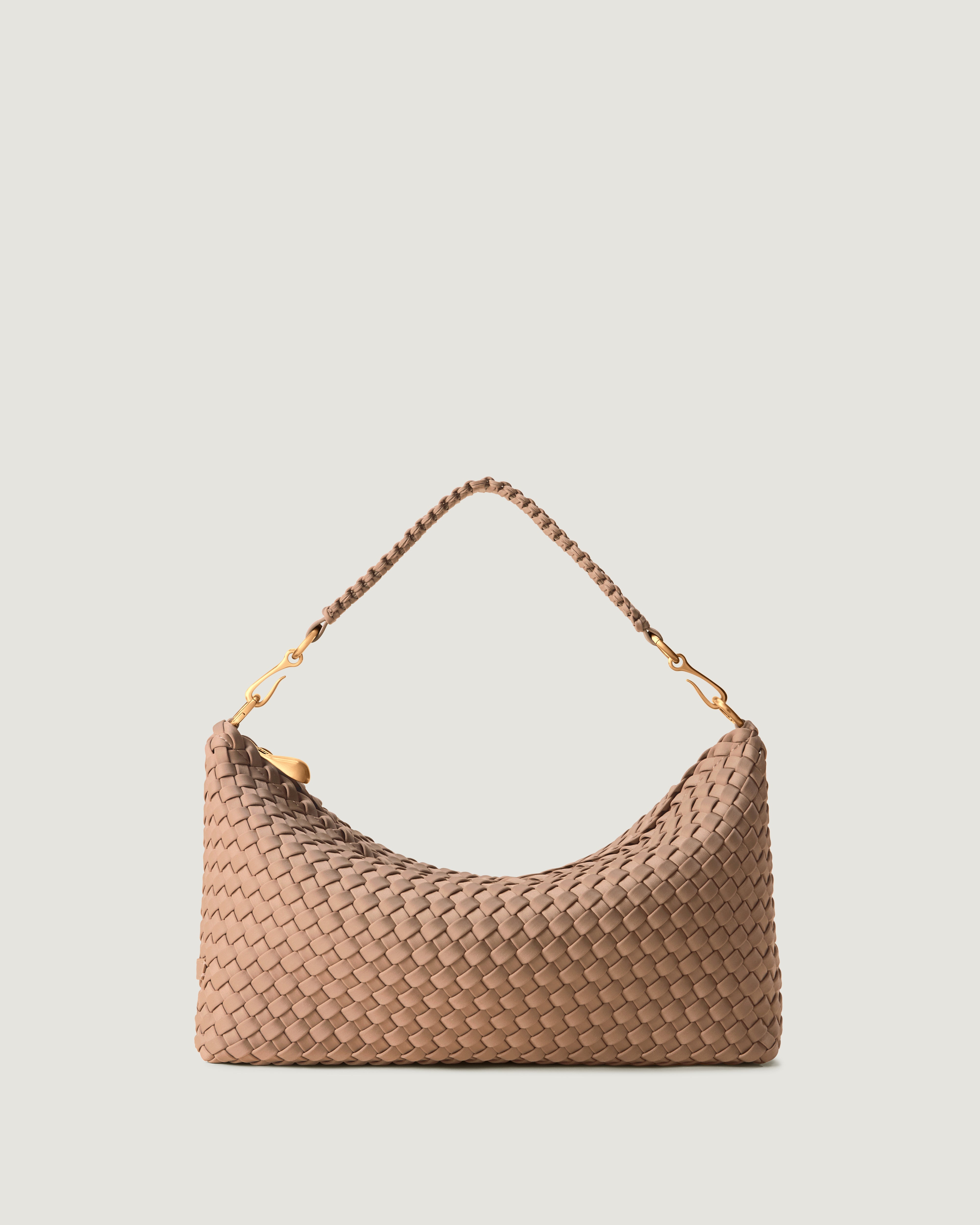 Porto Half-Moon in Seychelles, a light beige tone, in handwoven neoprene, featuring a zip closure, and strap with hand-stitched detailing.