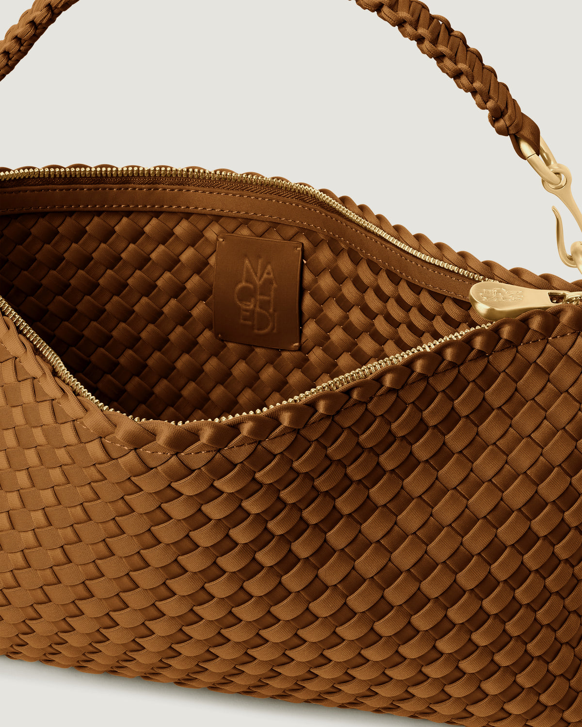 Interior close-up of Porto Small Half-Moon in Teak showing its zip closure, and unlined interior.
