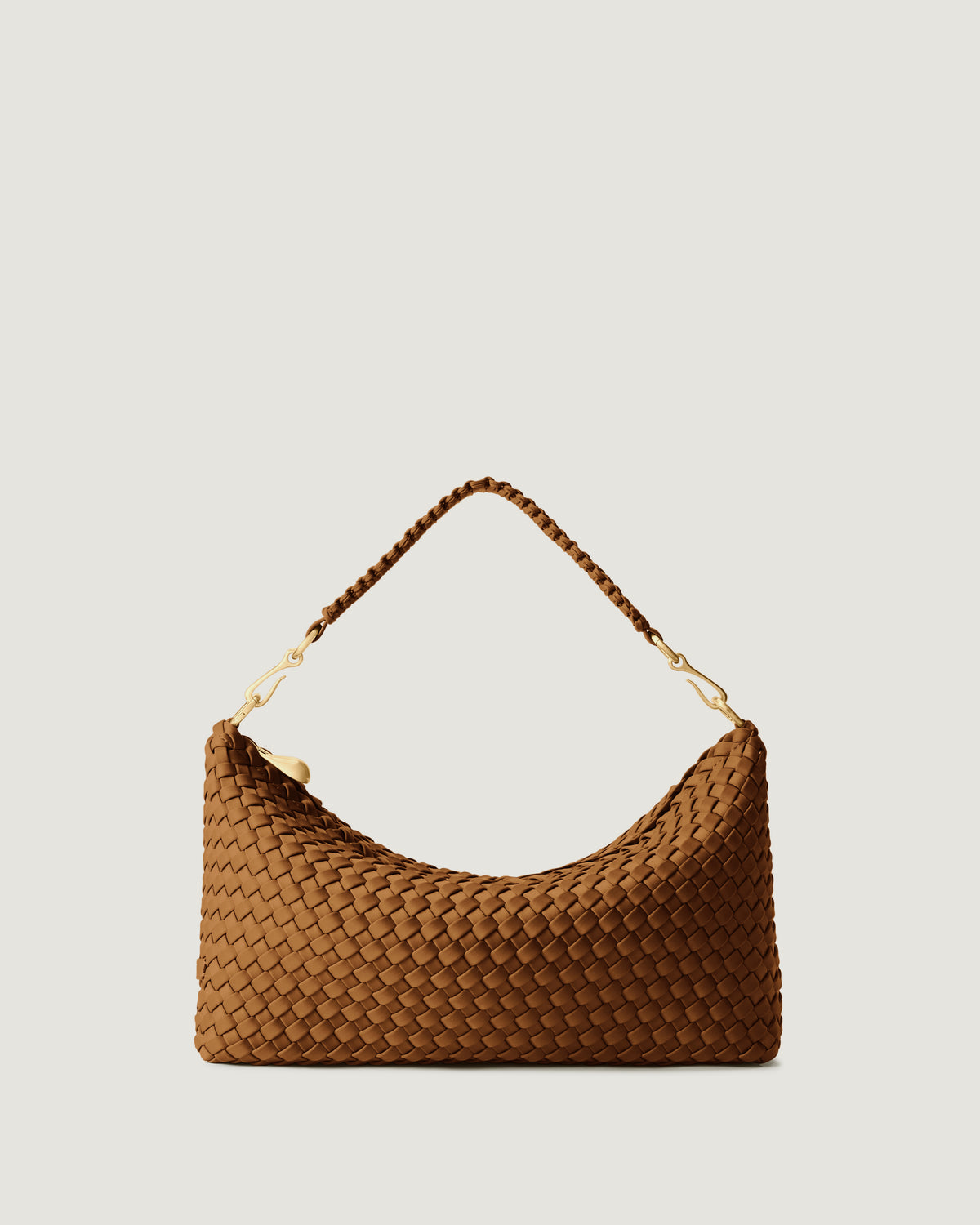 Porto Small Half-Moon in Teak, a saddle brown tone, in handwoven neoprene, featuring a zip closure, and strap with hand-stitched detailing.