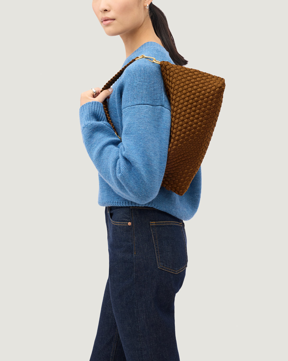Porto Half-Moon in Teak shown on model to illustrate scale and soft silhouette.