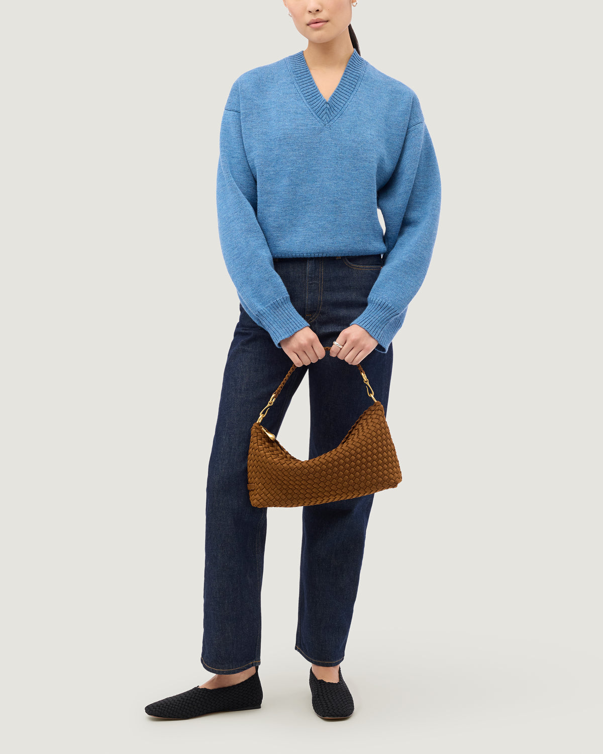 Porto Half-Moon in Teak shown on model to illustrate scale and soft silhouette.