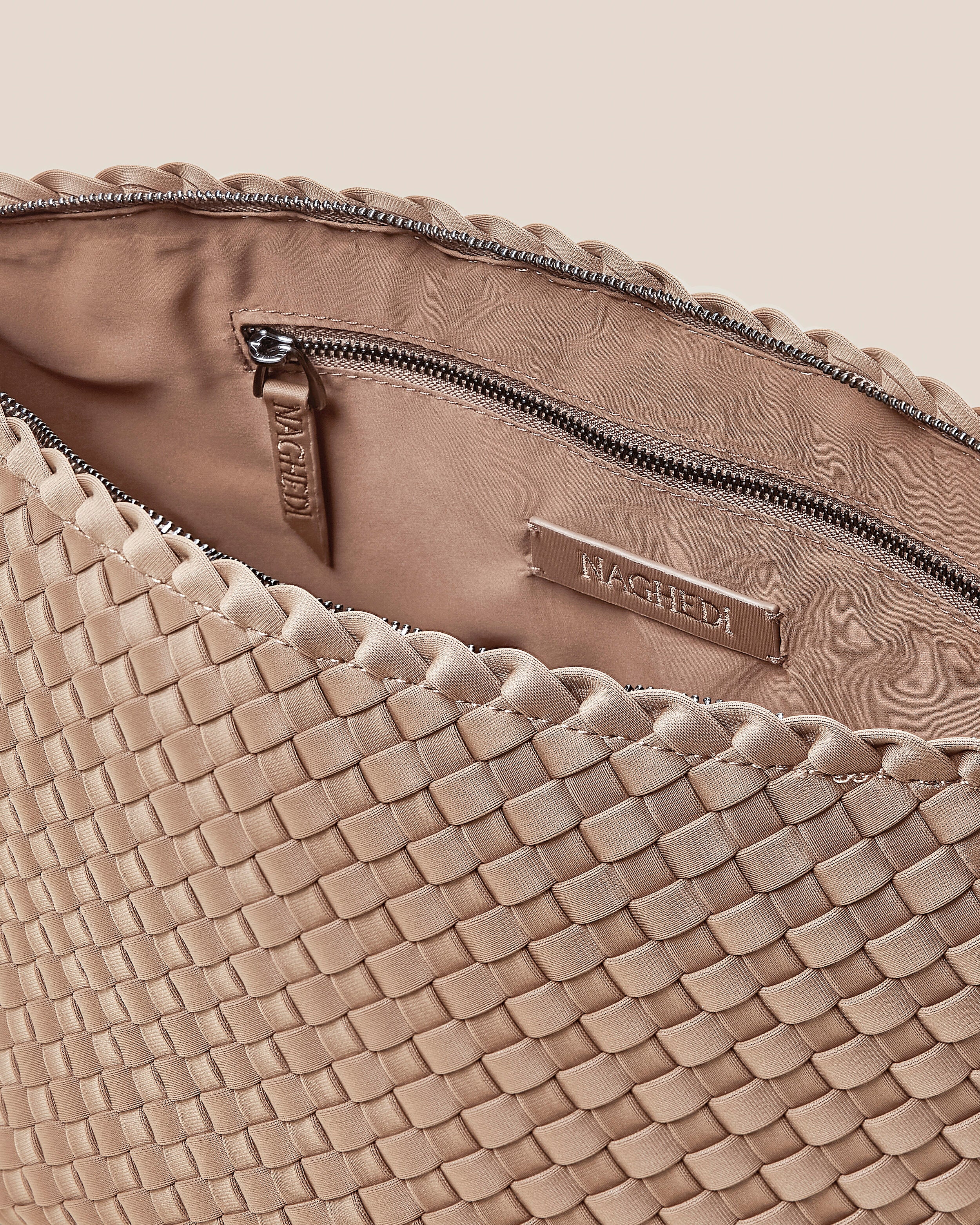 Interior close-up of Portofino Cosmetic Pouch in Cashmere showing its zip closure, interior pockets, and wipe-clean nylon interior.