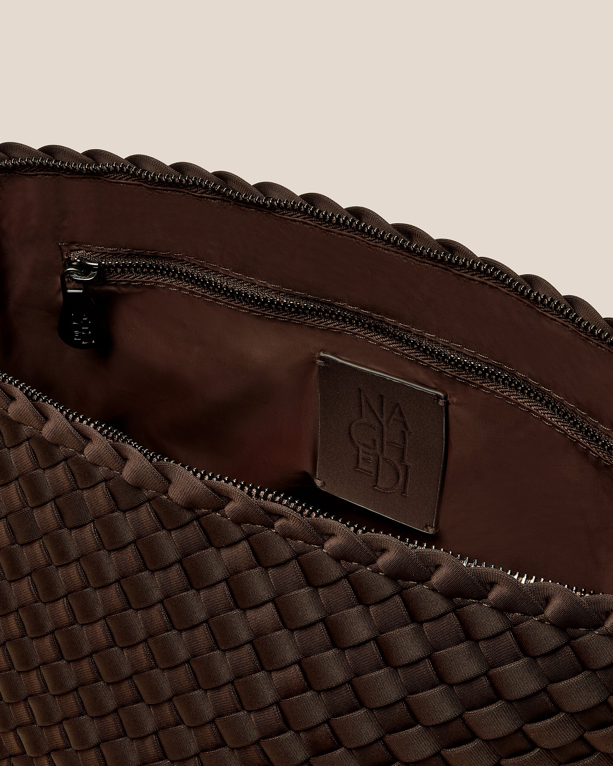 Interior close-up of Portofino Large Cosmetic Pouch in Chocolate showing its zip closure, interior pockets, and wipe-clean nylon interior.