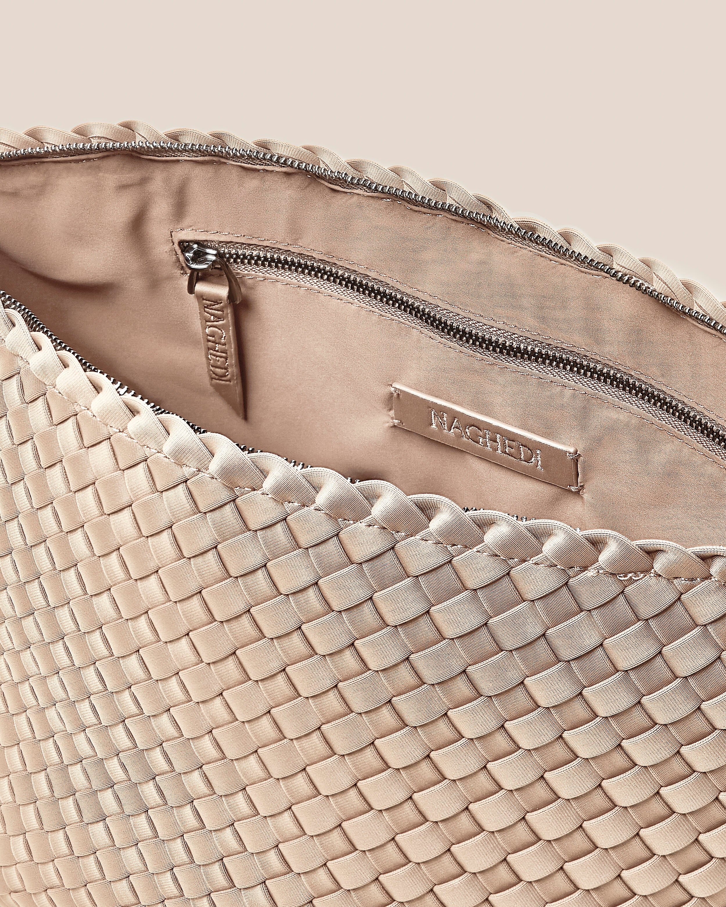 Interior close-up of Portofino Cosmetic Pouch in Ecru showing its zip closure, interior pockets, and wipe-clean nylon interior.