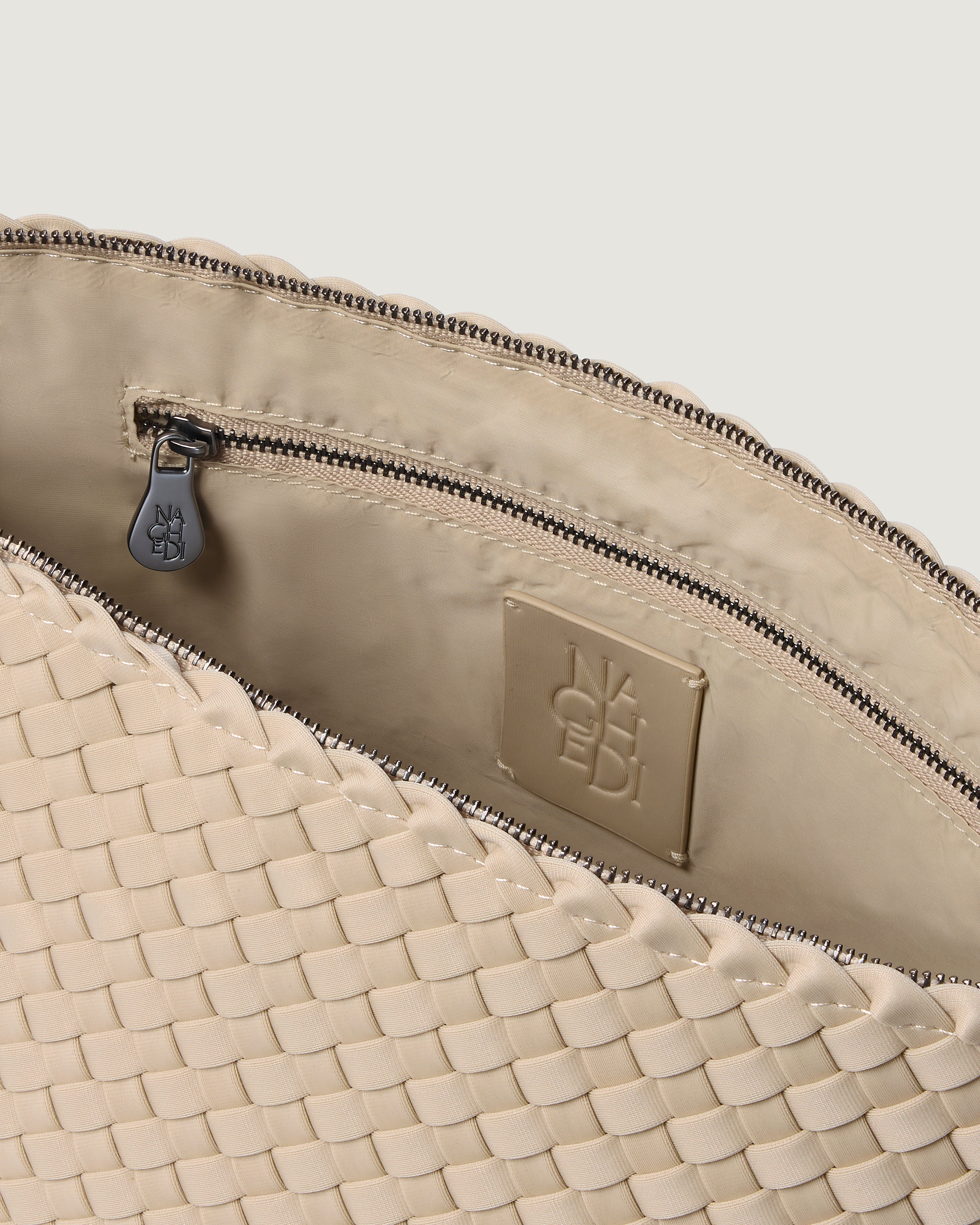 Interior close-up of Portofino Cosmetic Pouch in Ecru showing its zip closure, interior pockets, and wipe-clean nylon interior.