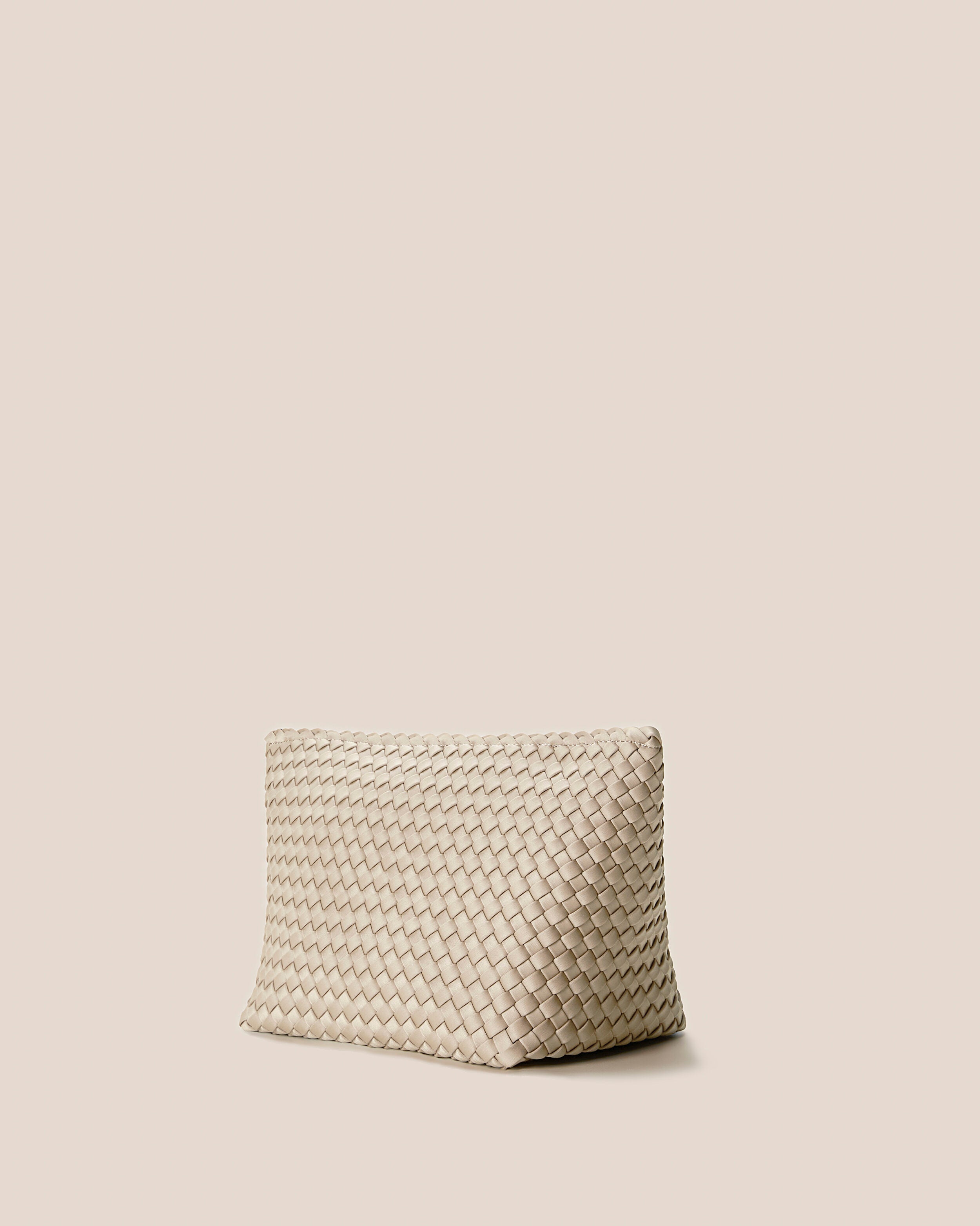 Portofino Cosmetic Pouch in Ecru shown from a side angle, highlighting its handwoven neoprene construction and zip closure.