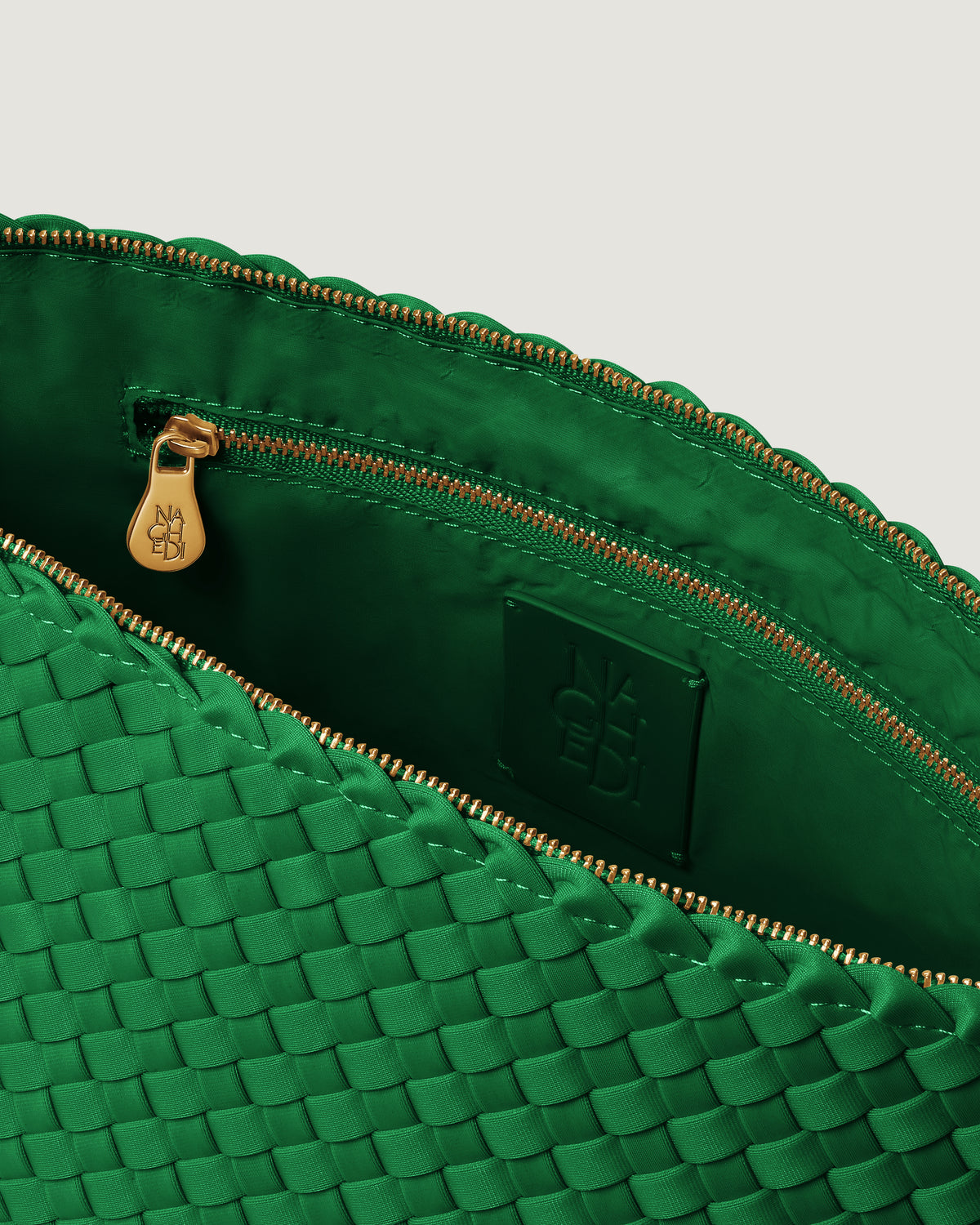 Interior close-up of Portofino Cosmetic Pouch in Emerald showing its zip closure, interior pocket, and wipe-clean nylon interior.