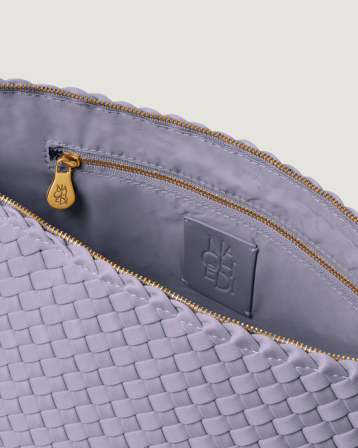 Interior close-up of Portofino Cosmetic Pouch in Lilac showing its zip closure, interior pocket, and wipe-clean nylon interior.