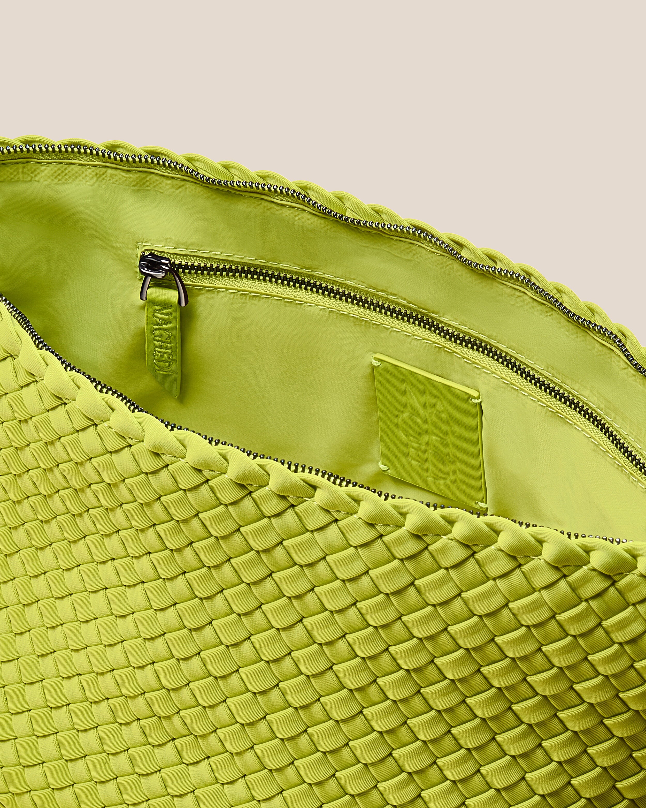 Interior close-up of Portofino Cosmetic Pouch in Matcha showing its zip closure, interior pockets, and wipe-clean nylon interior.