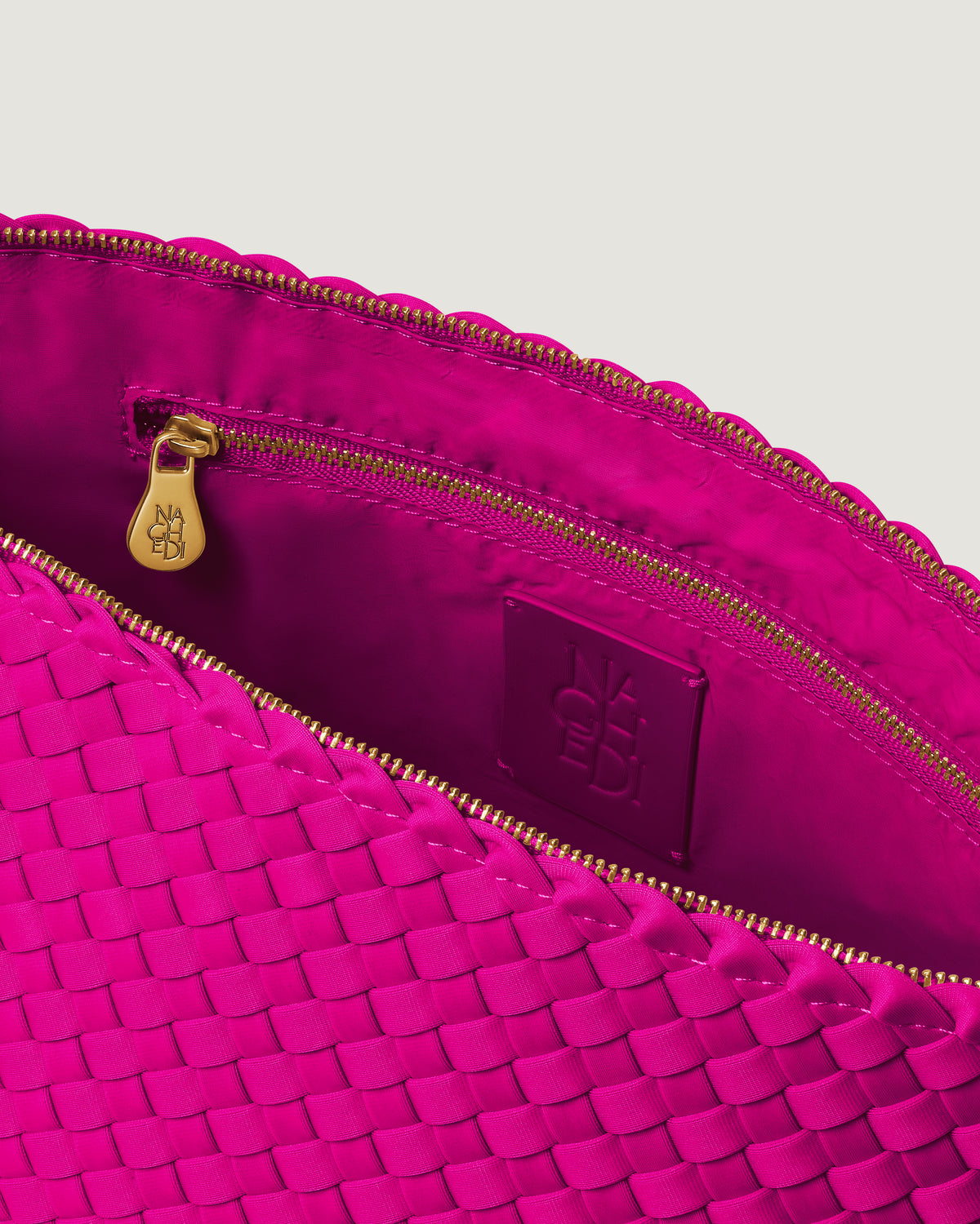 Interior close-up of Portofino Cosmetic Pouch in Miami Pink showing its zip closure, interior pocket, and wipe-clean nylon interior.