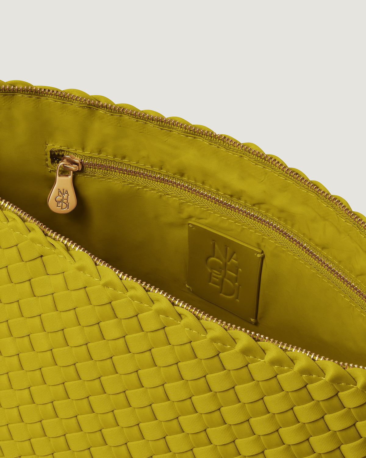 Interior close-up of Portofino Cosmetic Pouch in Ochre showing its zip closure, interior pocket, and wipe-clean nylon interior.