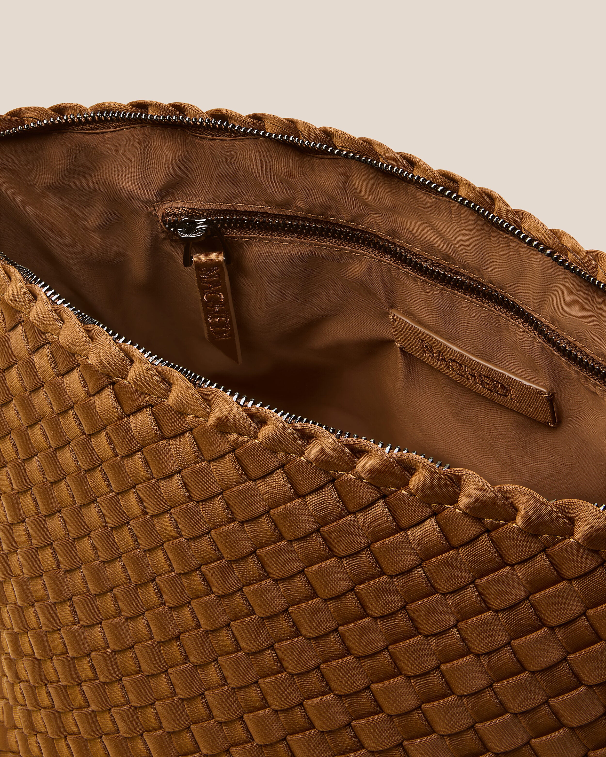Interior close-up of Portofino Cosmetic Pouch in Teak showing its zip closure, interior pockets, and wipe-clean nylon interior.