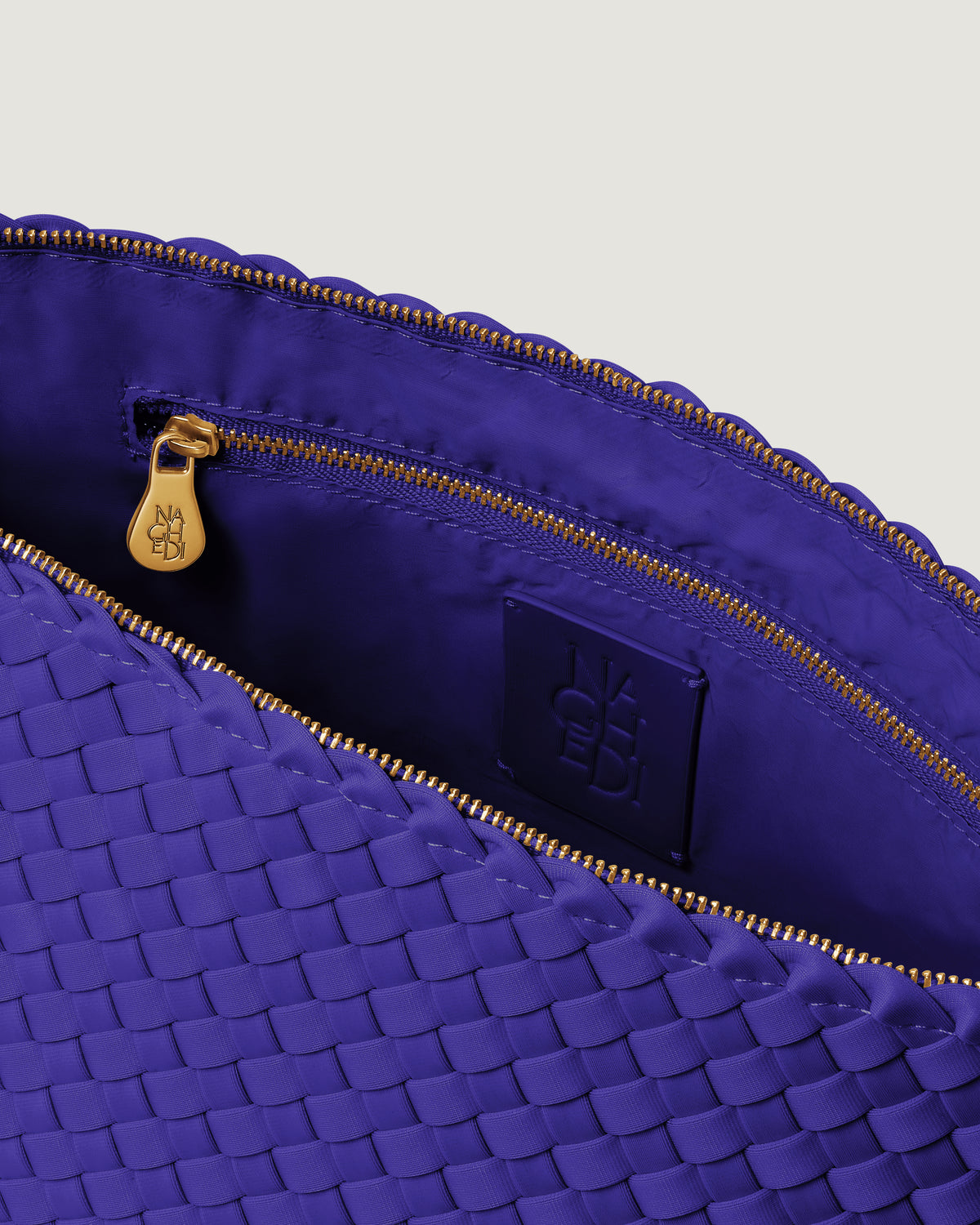Interior close-up of Portofino Cosmetic Pouch in Ultramarine showing its zip closure, interior pocket, and wipe-clean nylon interior.