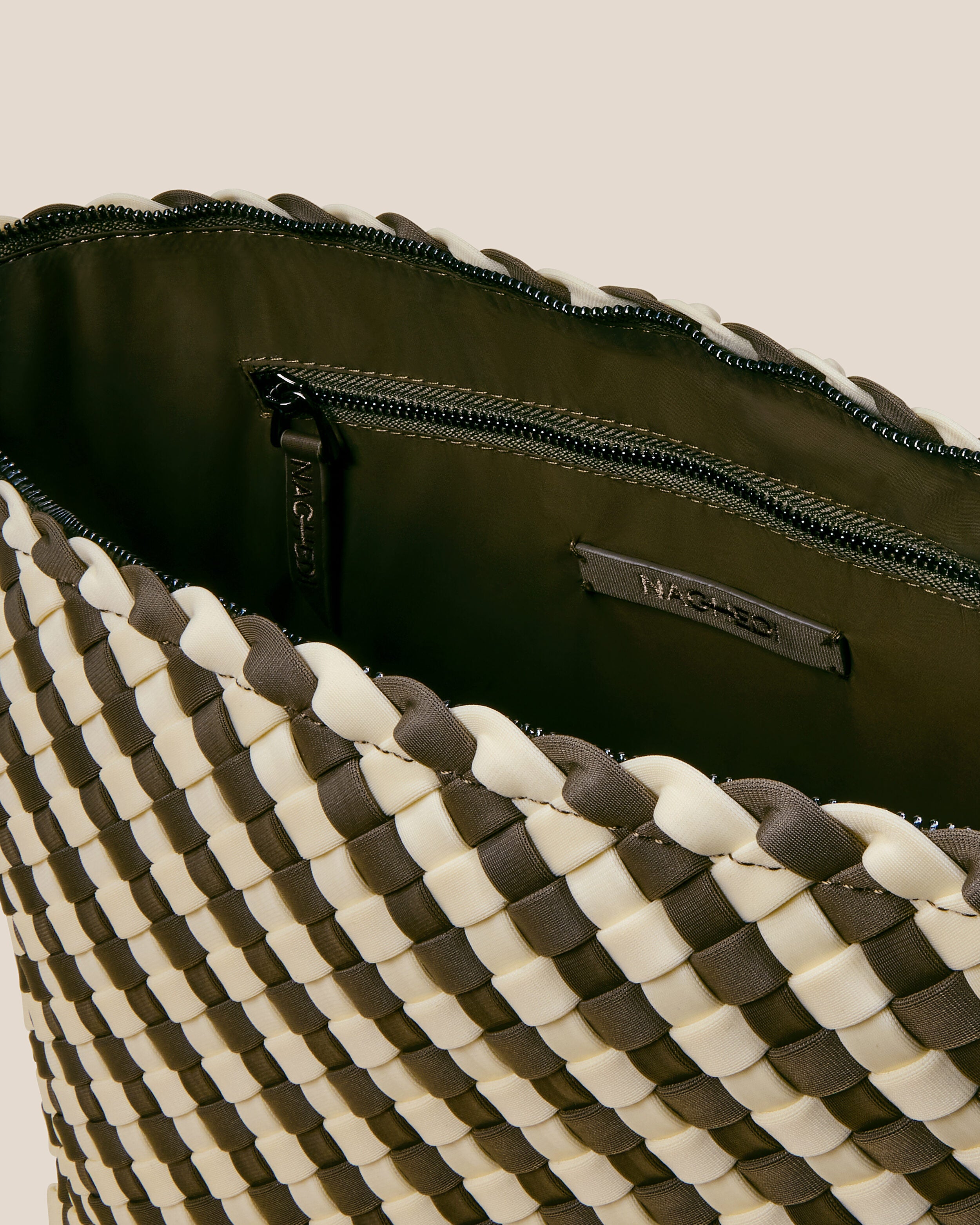 Interior close-up of Portofino Cosmetic Pouch in Carrara showing its zip closure, interior pockets, and wipe-clean nylon interior.