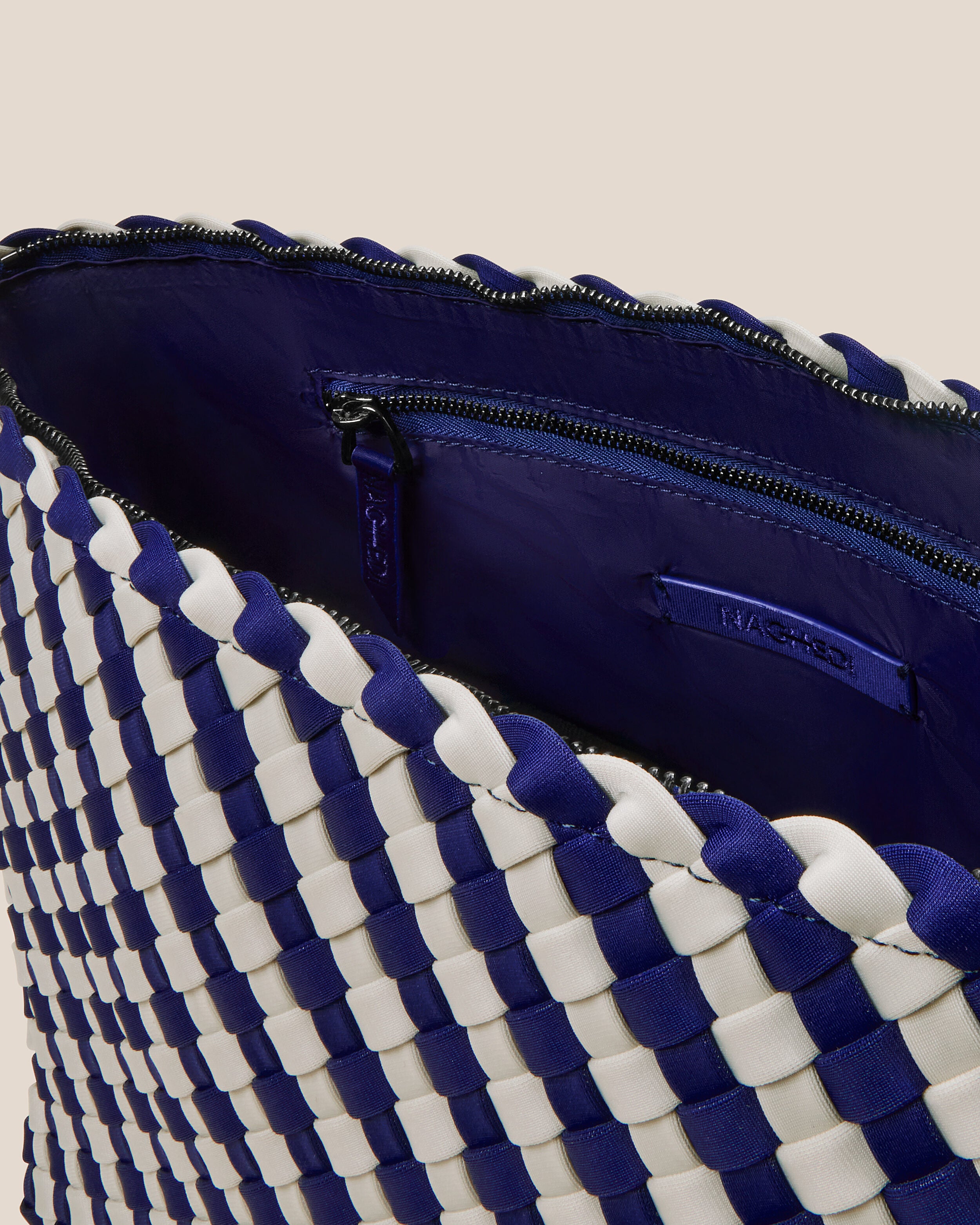 Interior close-up of Portofino Cosmetic Pouch in Venice showing its zip closure, interior pockets, and wipe-clean nylon interior.