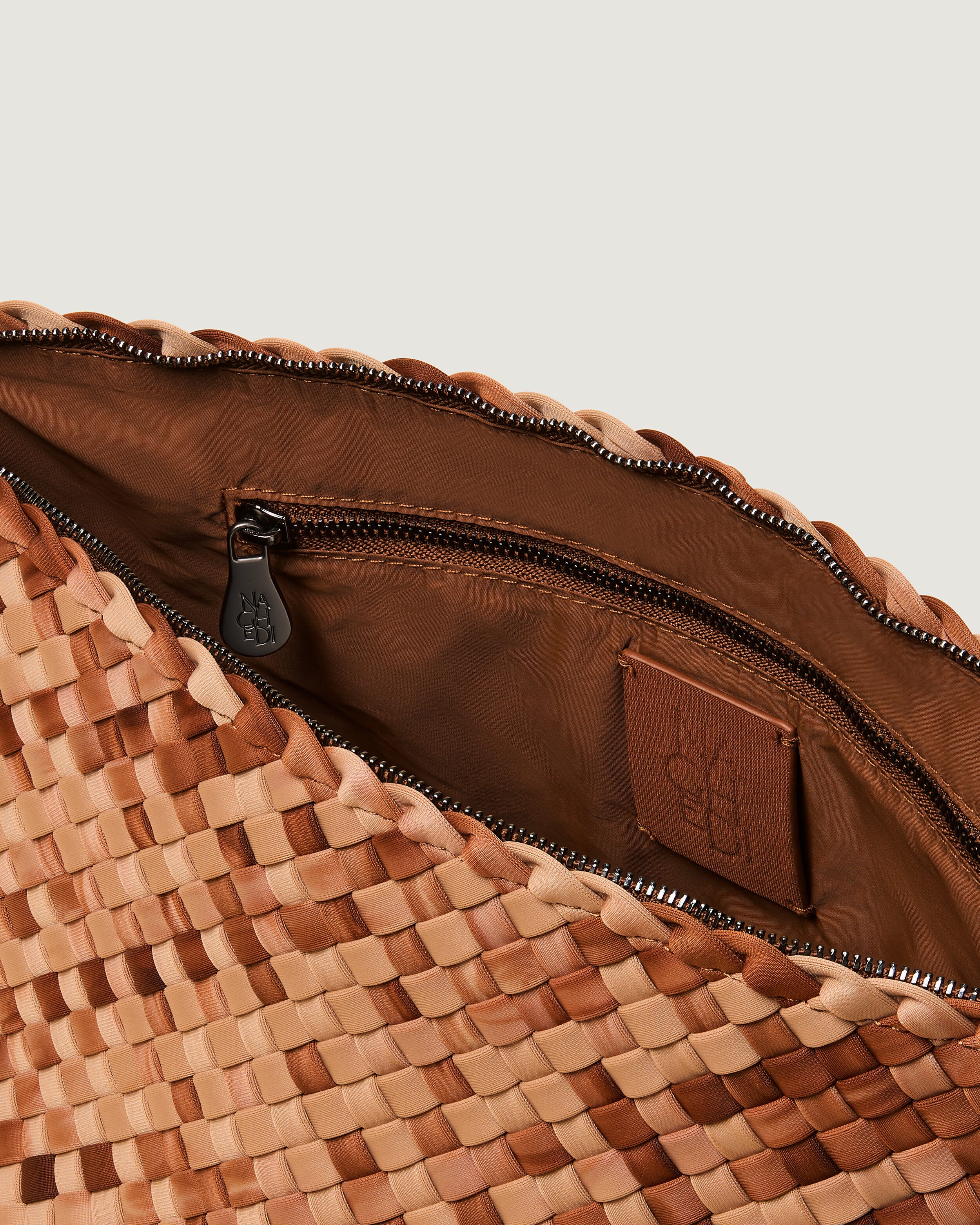 Interior close-up of Portofino Cosmetic Pouch in Fez showing its zip closure, interior pockets, and wipe-clean nylon interior.