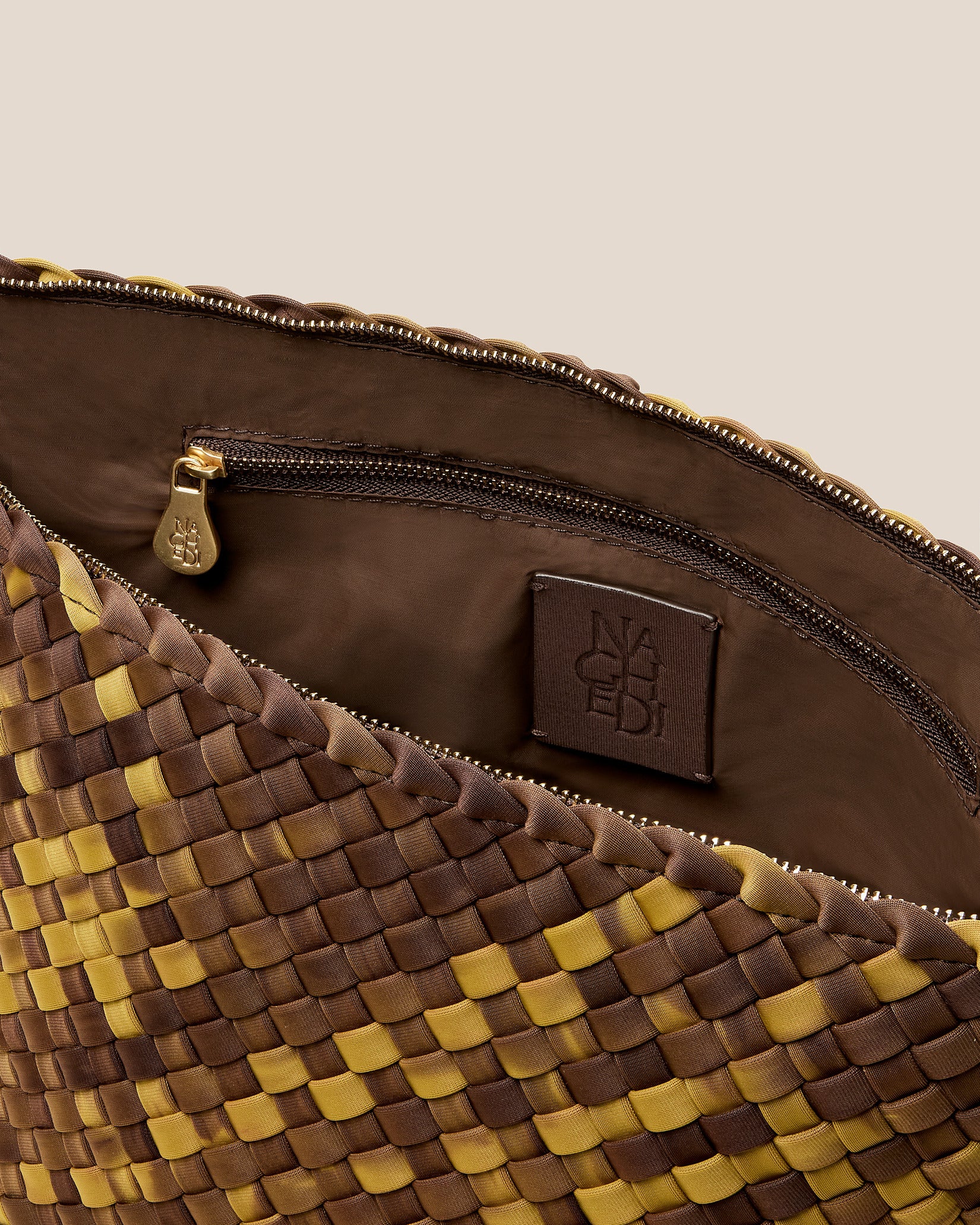 Interior close-up of Portofino Large Watercolor Cosmetic Pouch in Tortoiseshell showing its zip closure, interior pockets, and wipe-clean nylon interior.