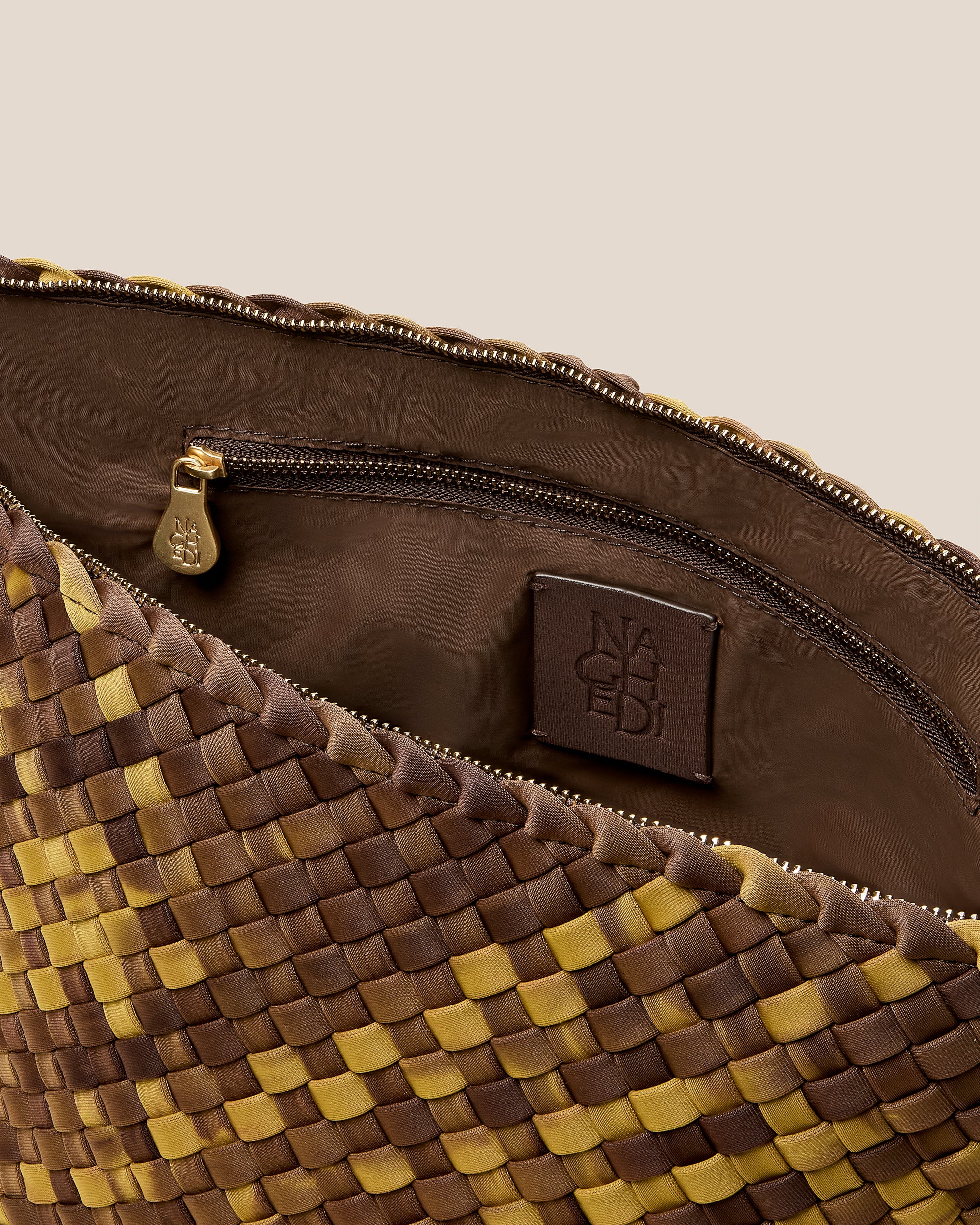 Interior close-up of Portofino Large Watercolor Cosmetic Pouch in Tortoiseshell showing its zip closure, interior pockets, and wipe-clean nylon interior.