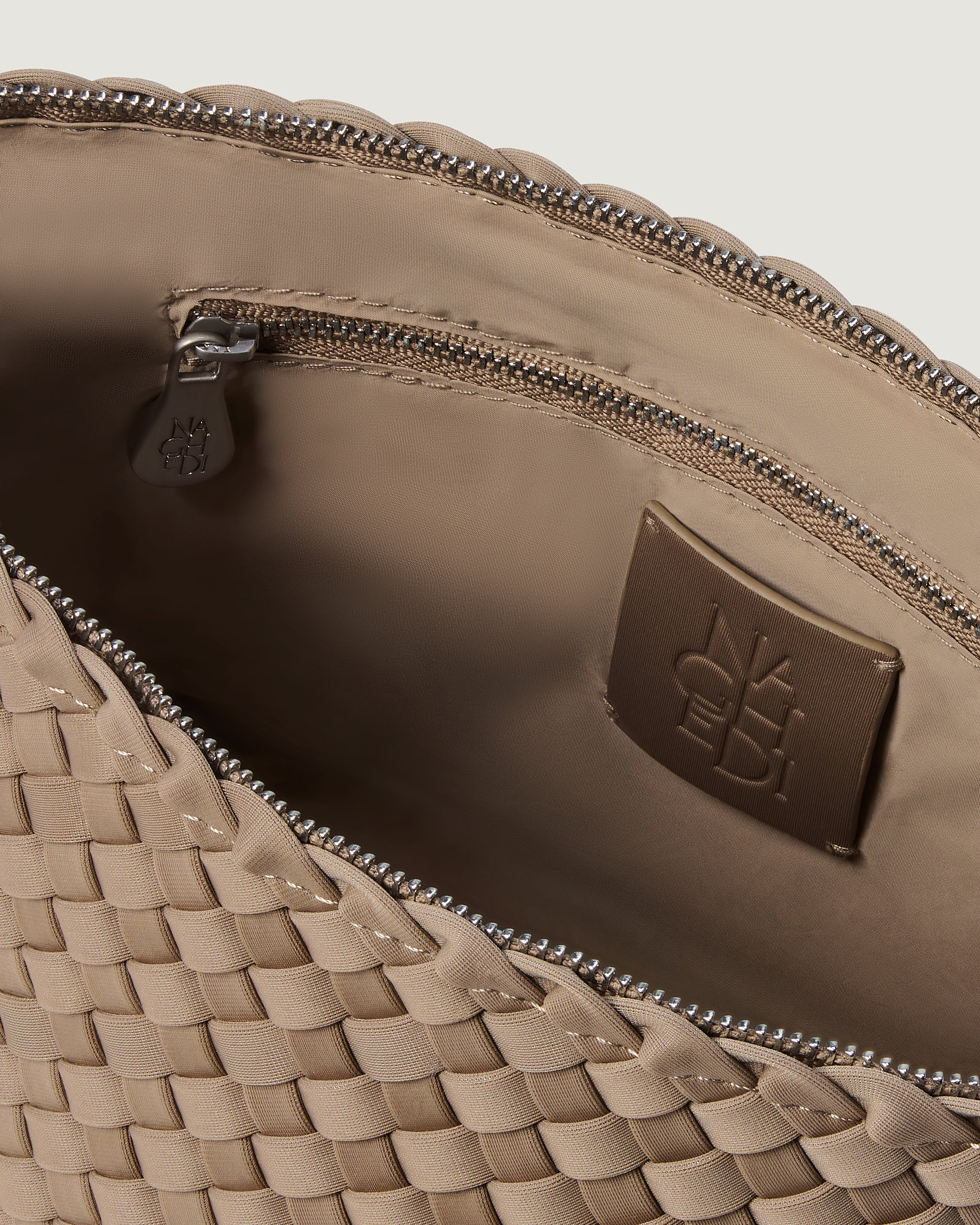 Interior close-up of Portofino Cosmetic Pouch in Cashmere showing its zip closure, interior pockets, and wipe-clean nylon interior.
