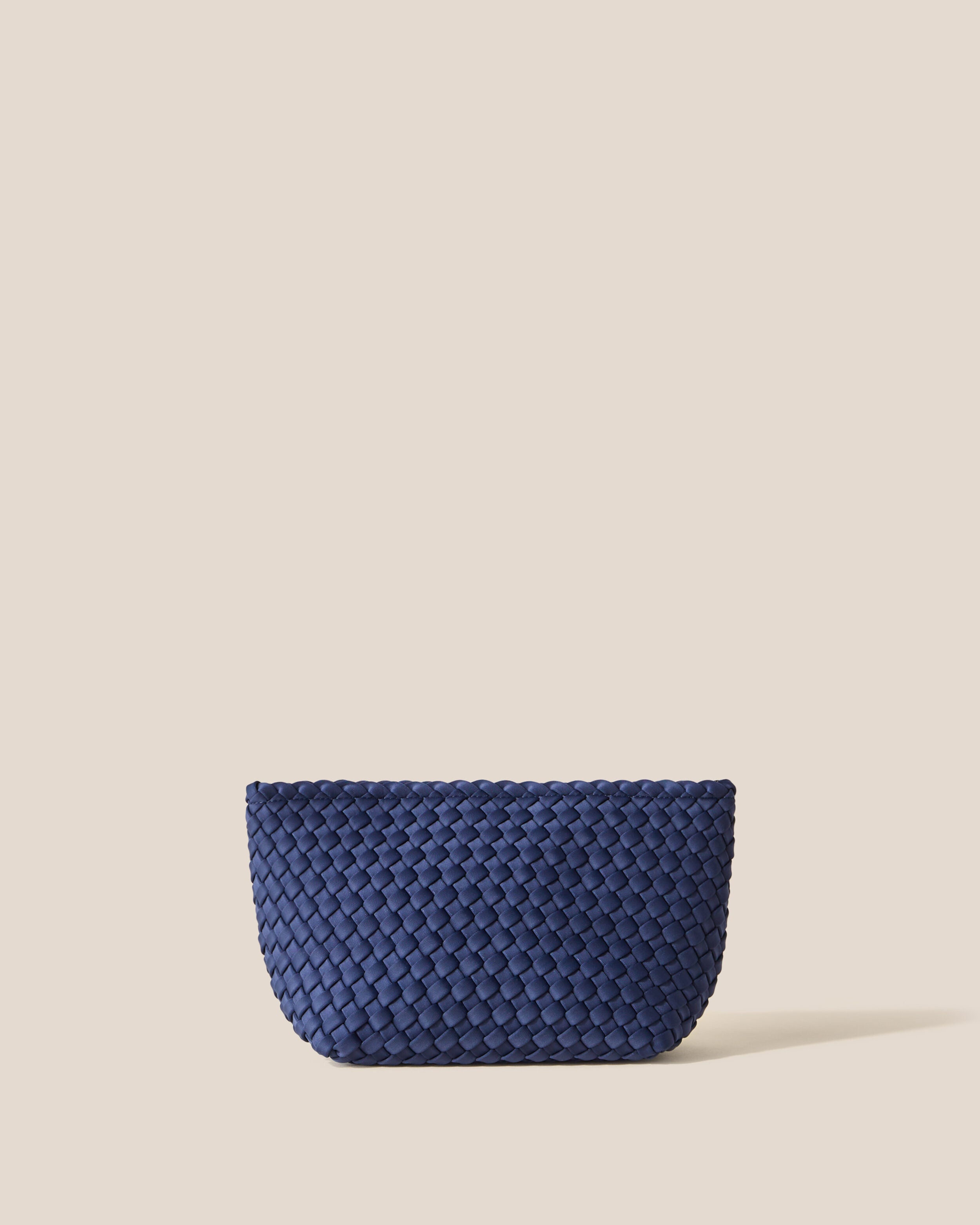 Portofino Cosmetic Pouch in Ink Blue, a navy blue tone, in handwoven neoprene, featuring a zip closure.