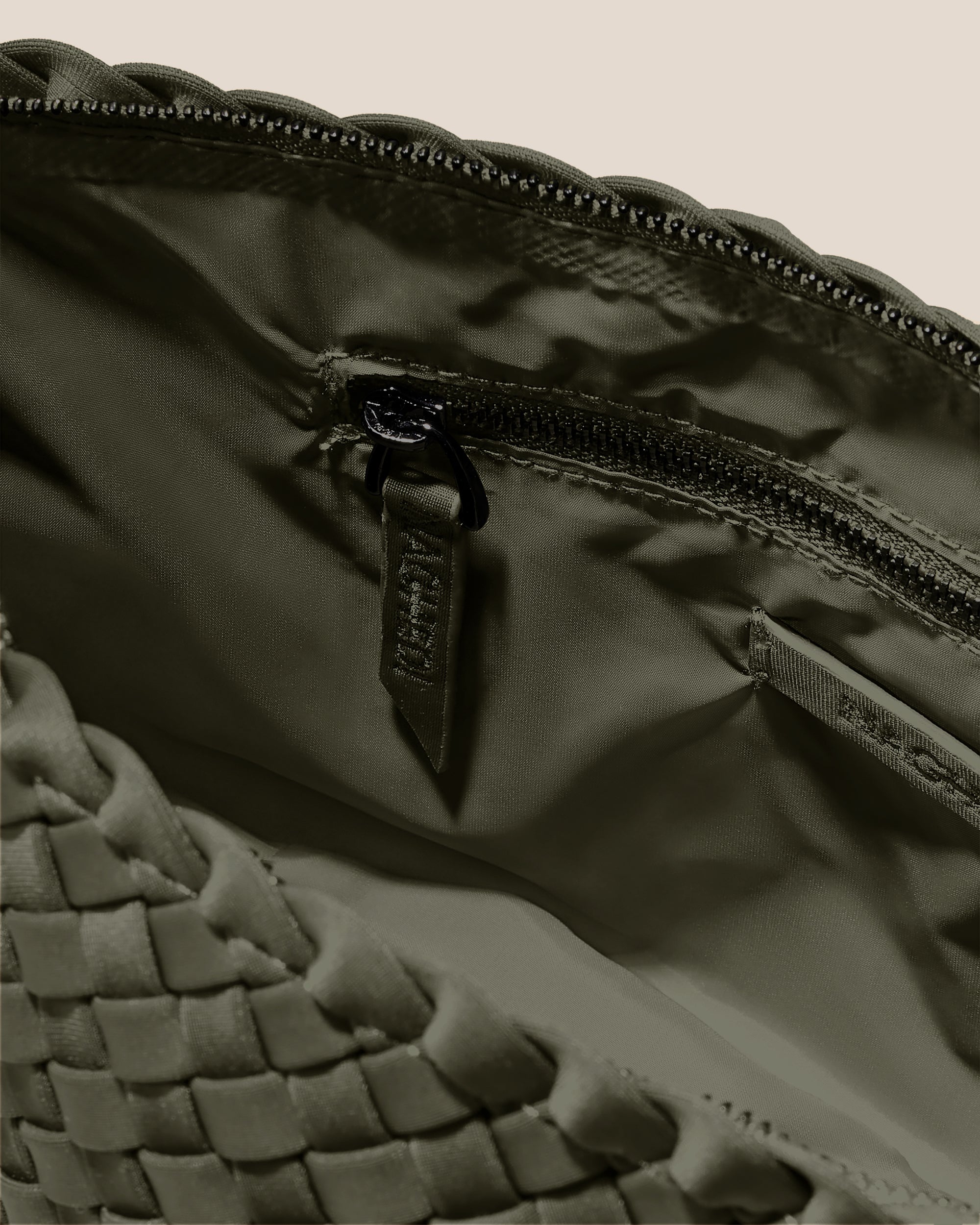 Interior close-up of Portofino Medium Cosmetic Pouch in Olive showing its zip closure, interior pockets, and wipe-clean nylon interior.