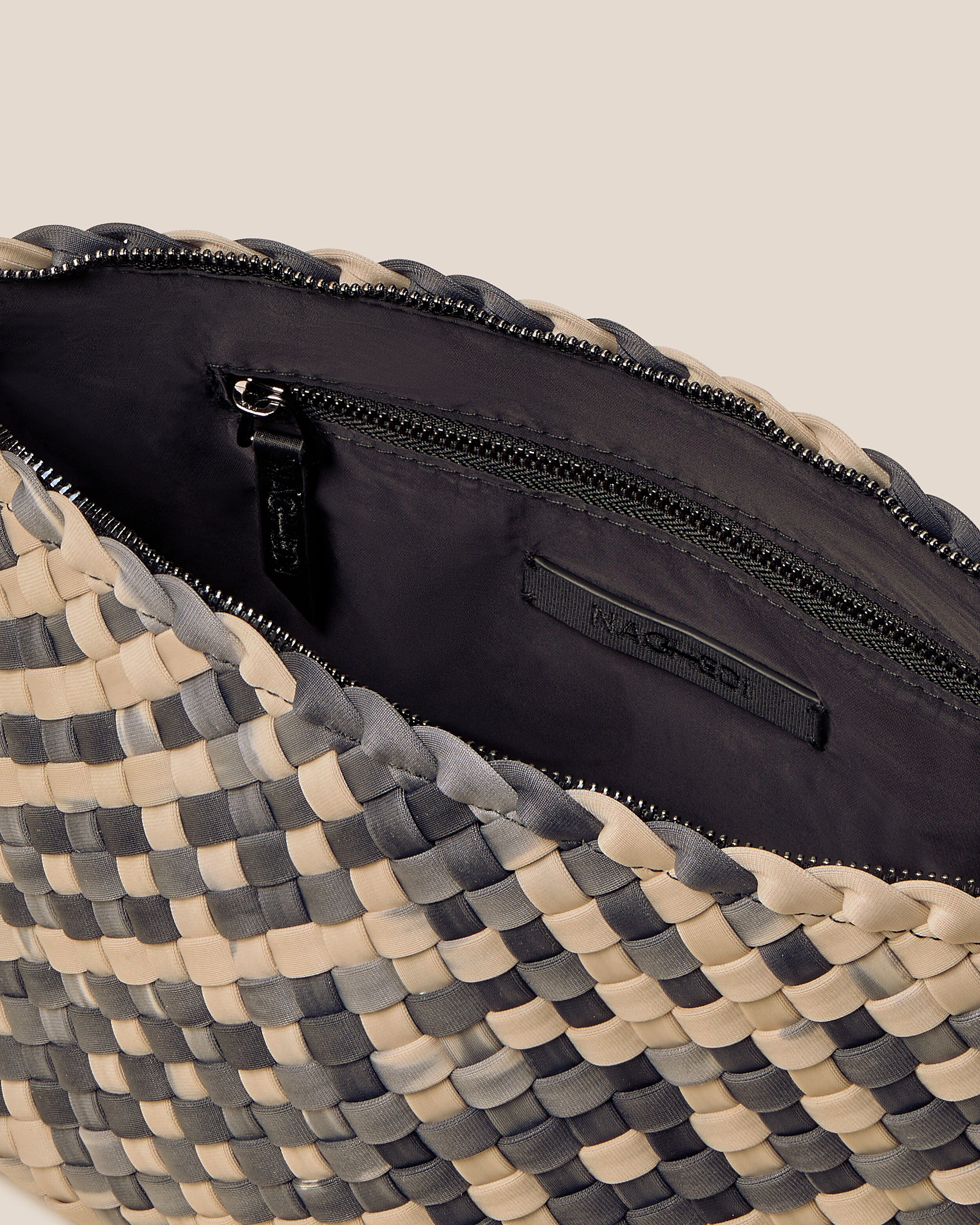 Interior close-up of Portofino Cosmetic Pouch in Nimbus showing its zip closure, interior pockets, and wipe-clean nylon interior.