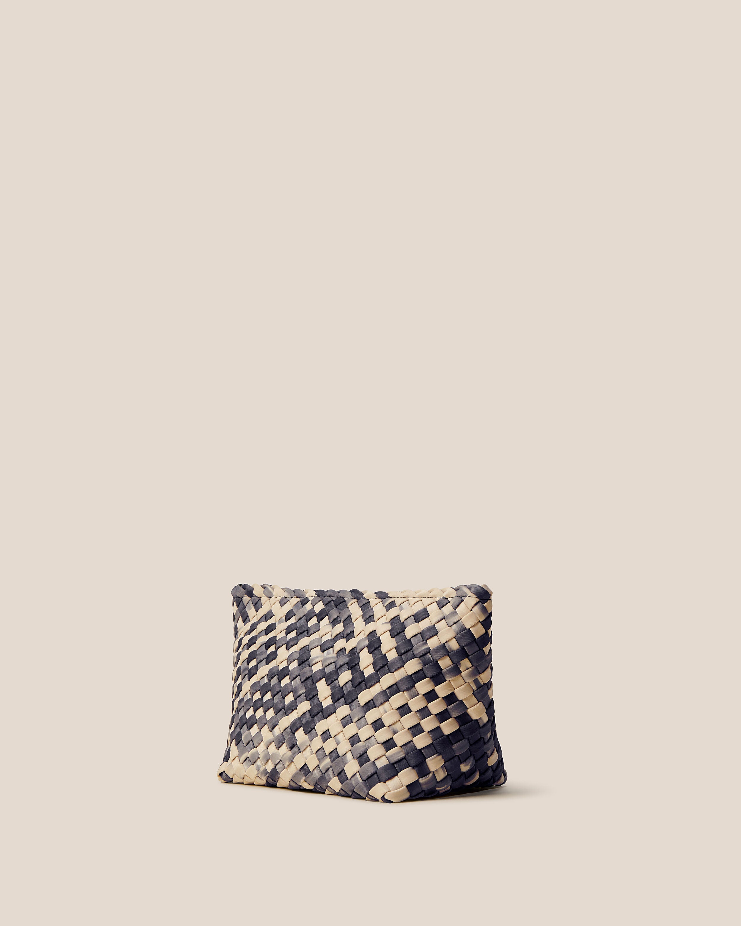 Portofino Cosmetic Pouch in Nimbus shown from a side angle, highlighting its handwoven neoprene construction and zip closure.