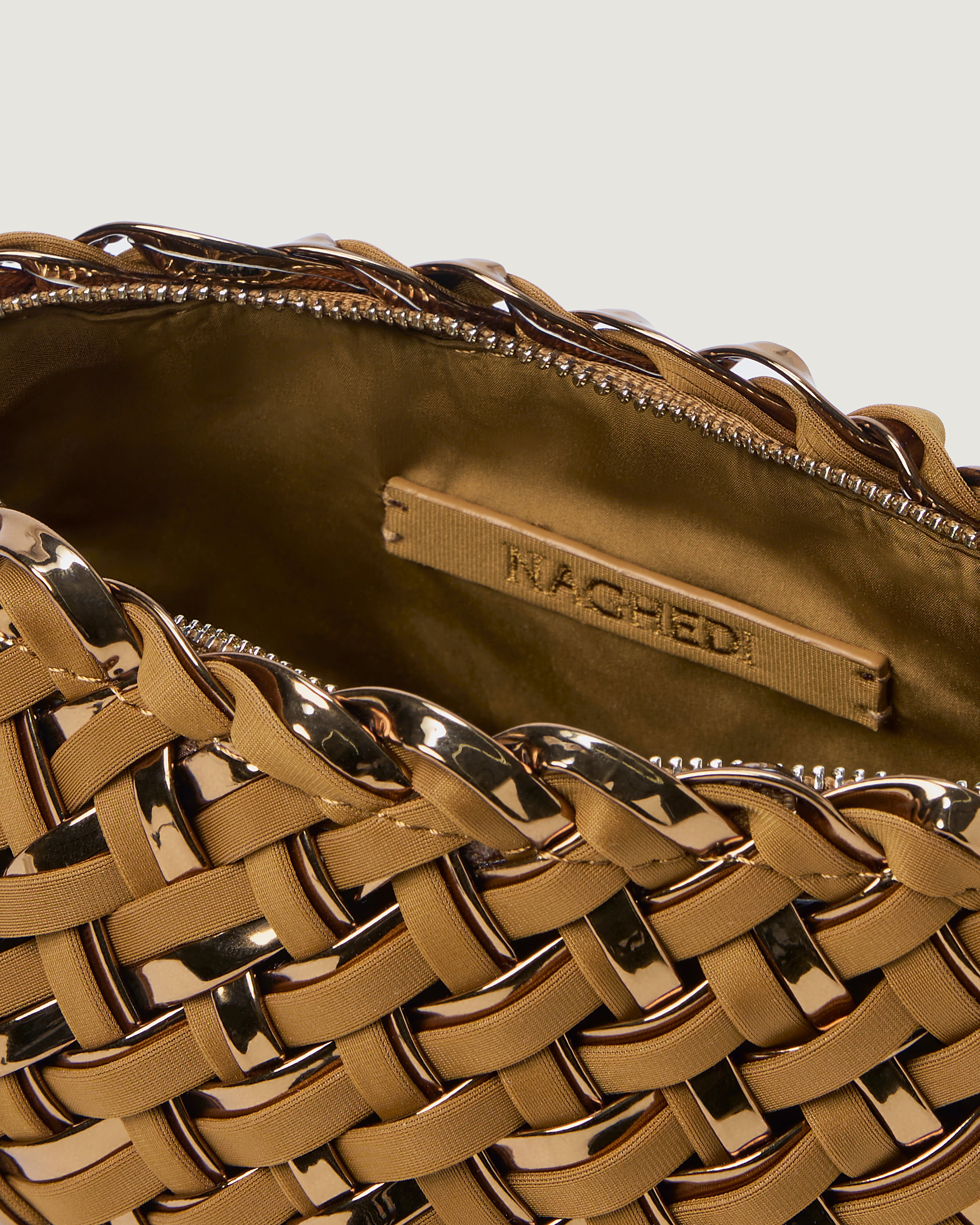 Close up of interior of handwoven neoprene pouch with gold zipper in gold satin and metallic coated neoprene