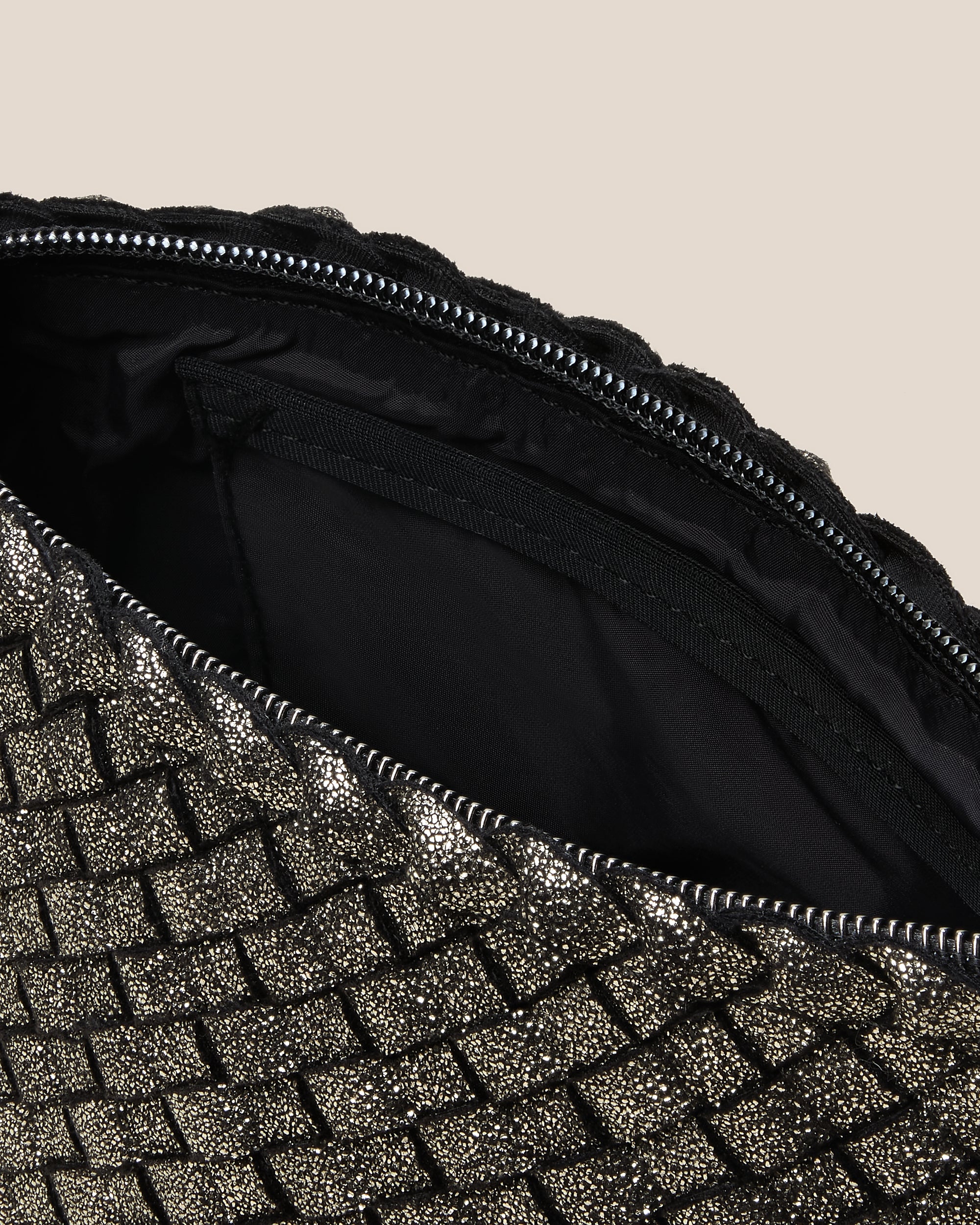 Interior close-up of Portofino Petit Metallic Cosmetic Pouch in Etoile showing its zip closure, interior pocket, and wipe-clean nylon interior.