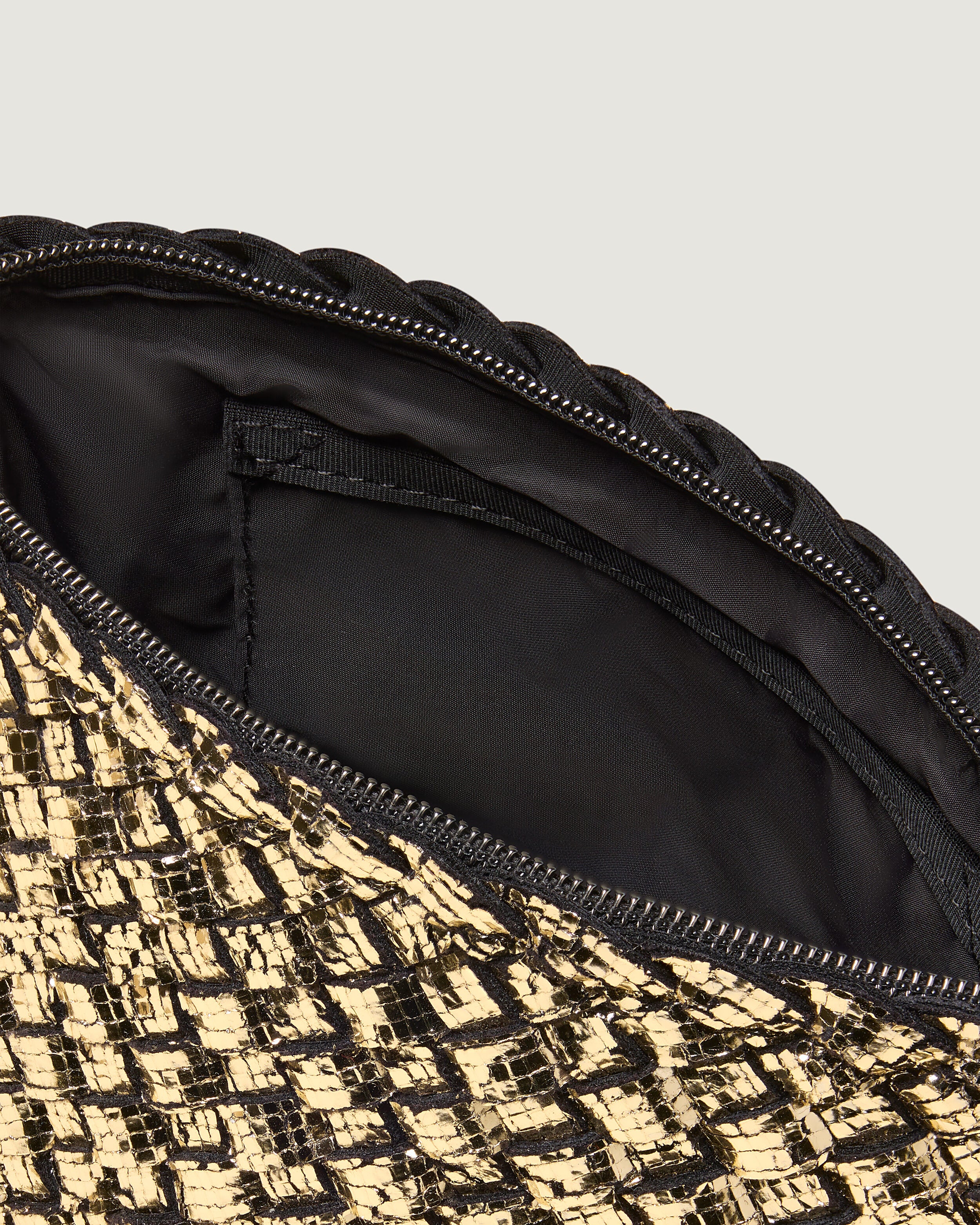 Interior close-up of Portofino Cosmetic Pouch in Gold showing its zip closure, interior pocket, and wipe-clean nylon interior.